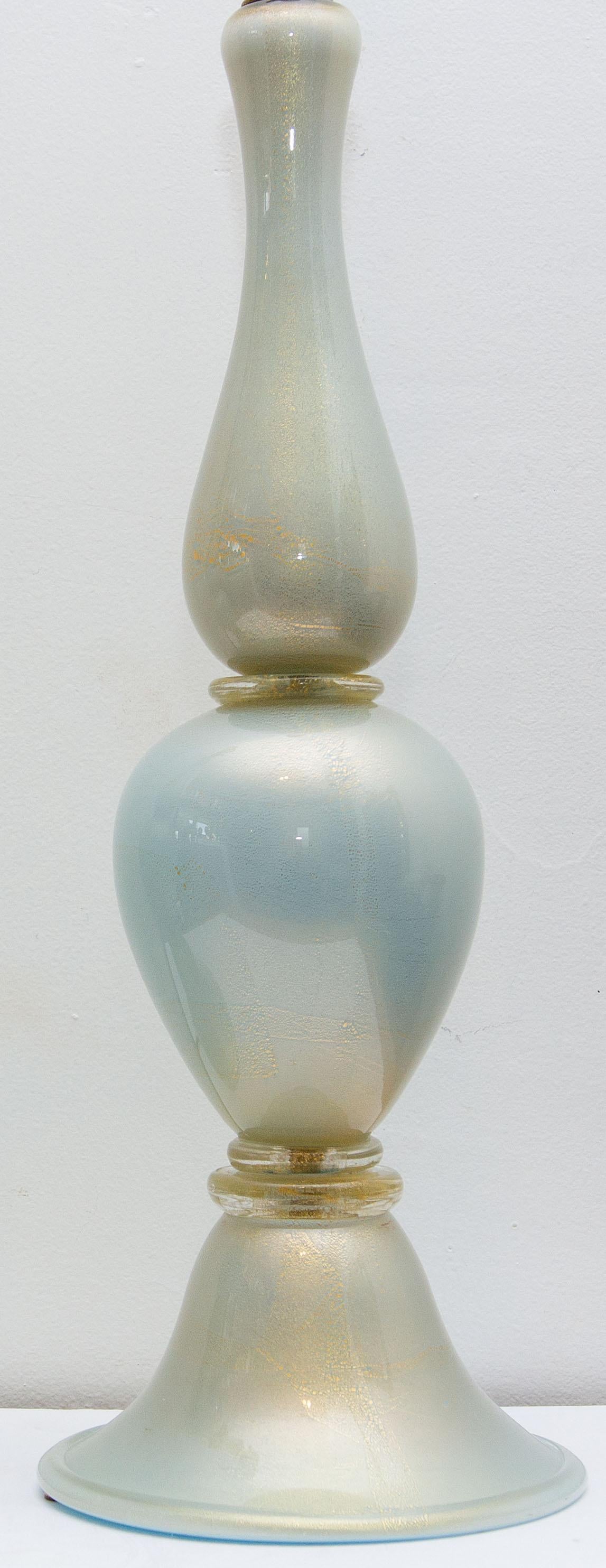 Exceptional pair of Venetian Murano glass table lamps. Finely made. Very unusual subtle color. Pearlescent light blue with gold flecks, circa 1960. No shade. Height to top of finial is 36
