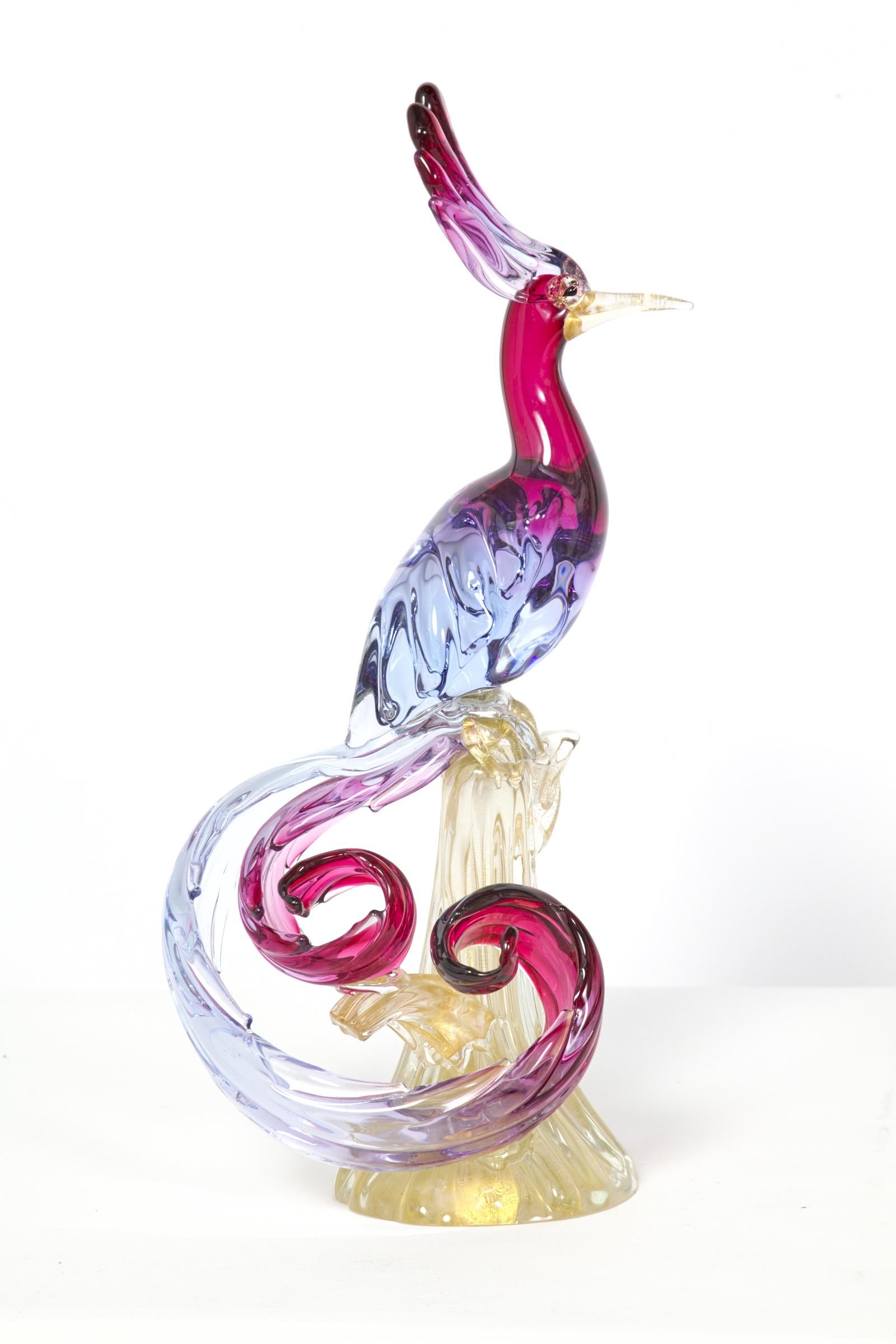 Stunning rare matching pair of large Murano birds of paradise. Beautiful color and detail. One is in excellent condition. The other has a beak which has a clean break at the base and has been glued in the past and a shallow chip to the bottom edge.