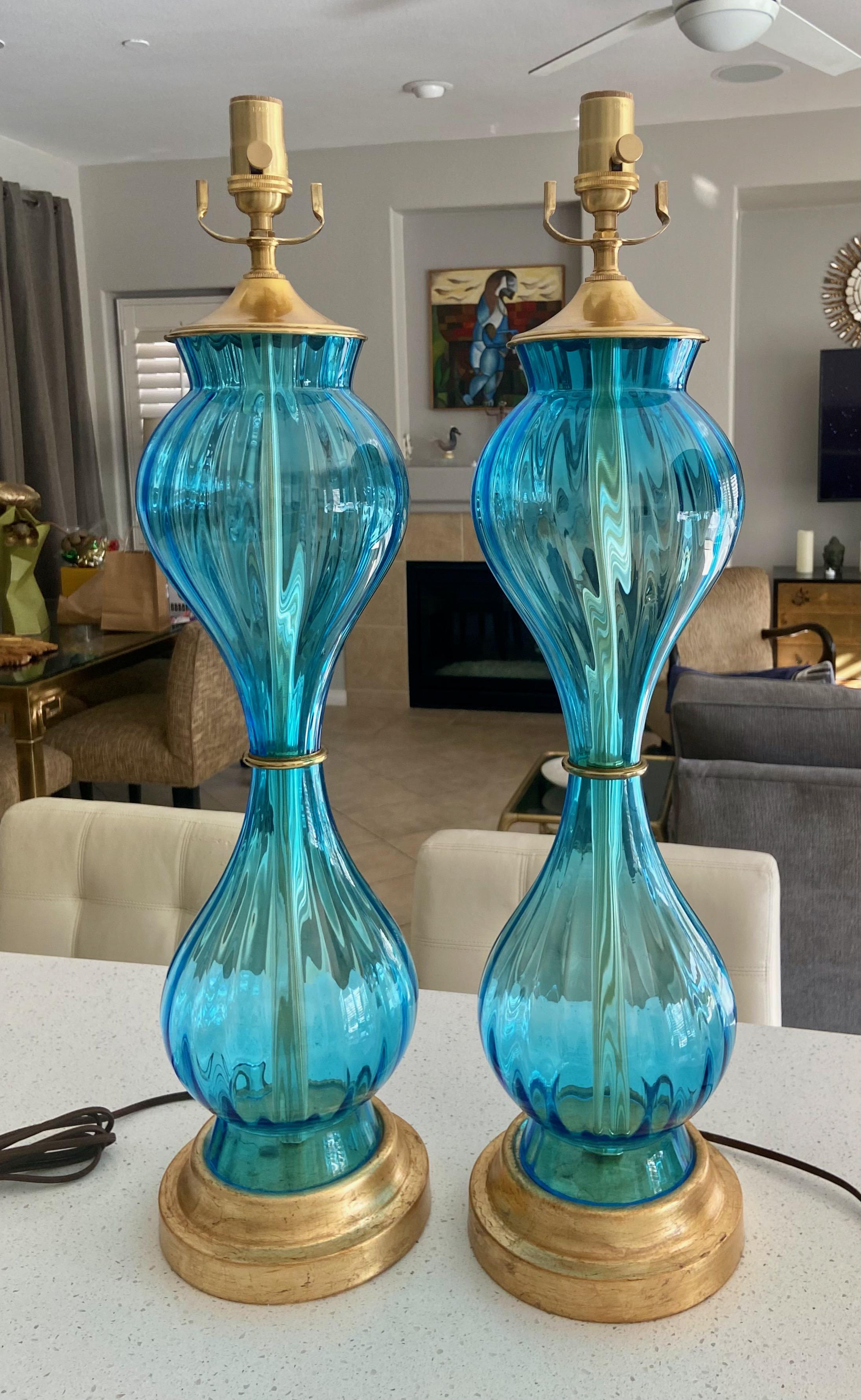 Pair of Murano Italian hand blown blue colored textured hourglass shape table lamps mounted on gilt metal bases. Newly wired with new 3 ways sockets and rayon cords.
 