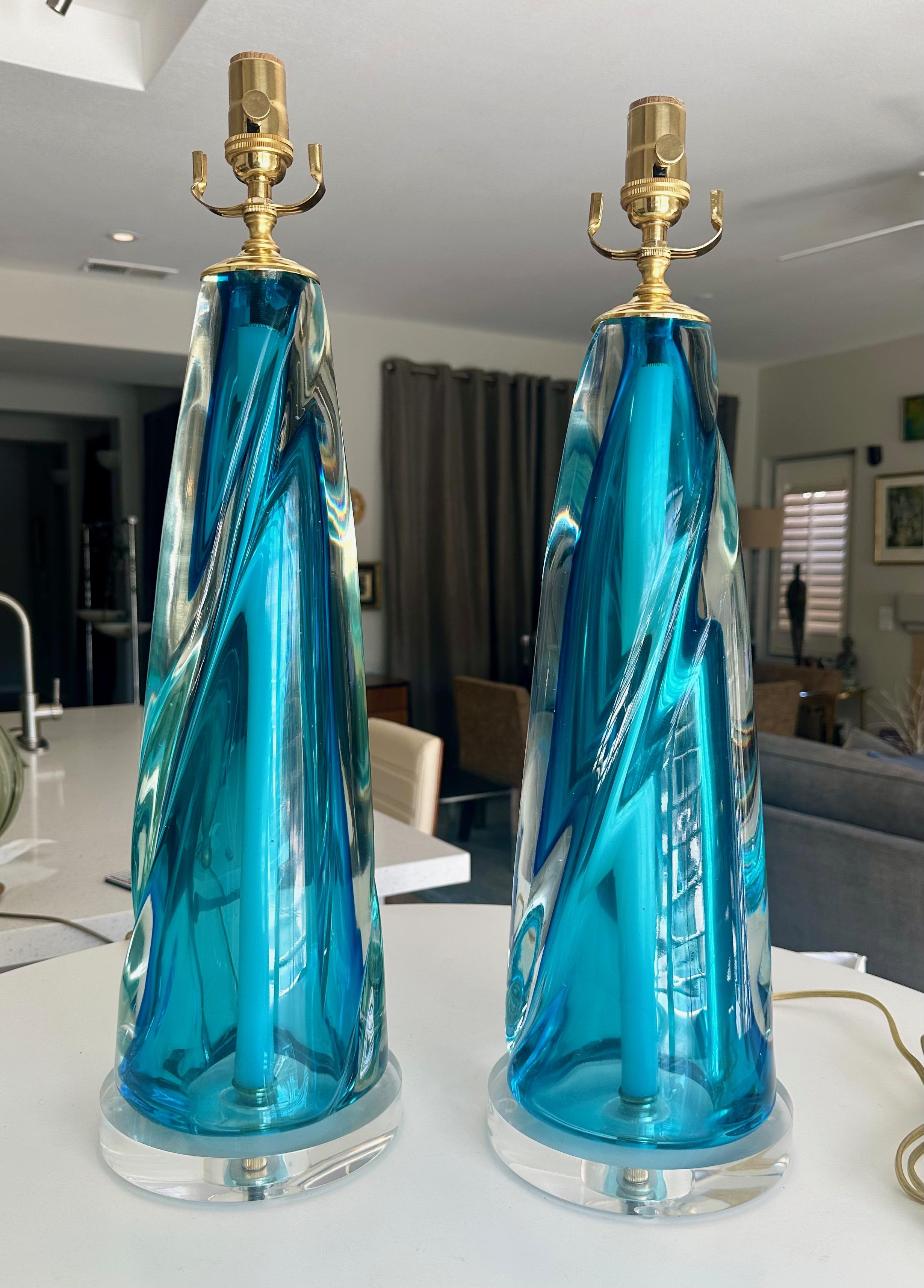 Pair of Murano Italian thick and solid (not hollow) hand blown clear and blue colored table lamps mounted on acrylic bases. Newly wired with new 3 ways sockets and cords. The glass is very heavy each weighing 25 pounds. One of the lamps is slightly