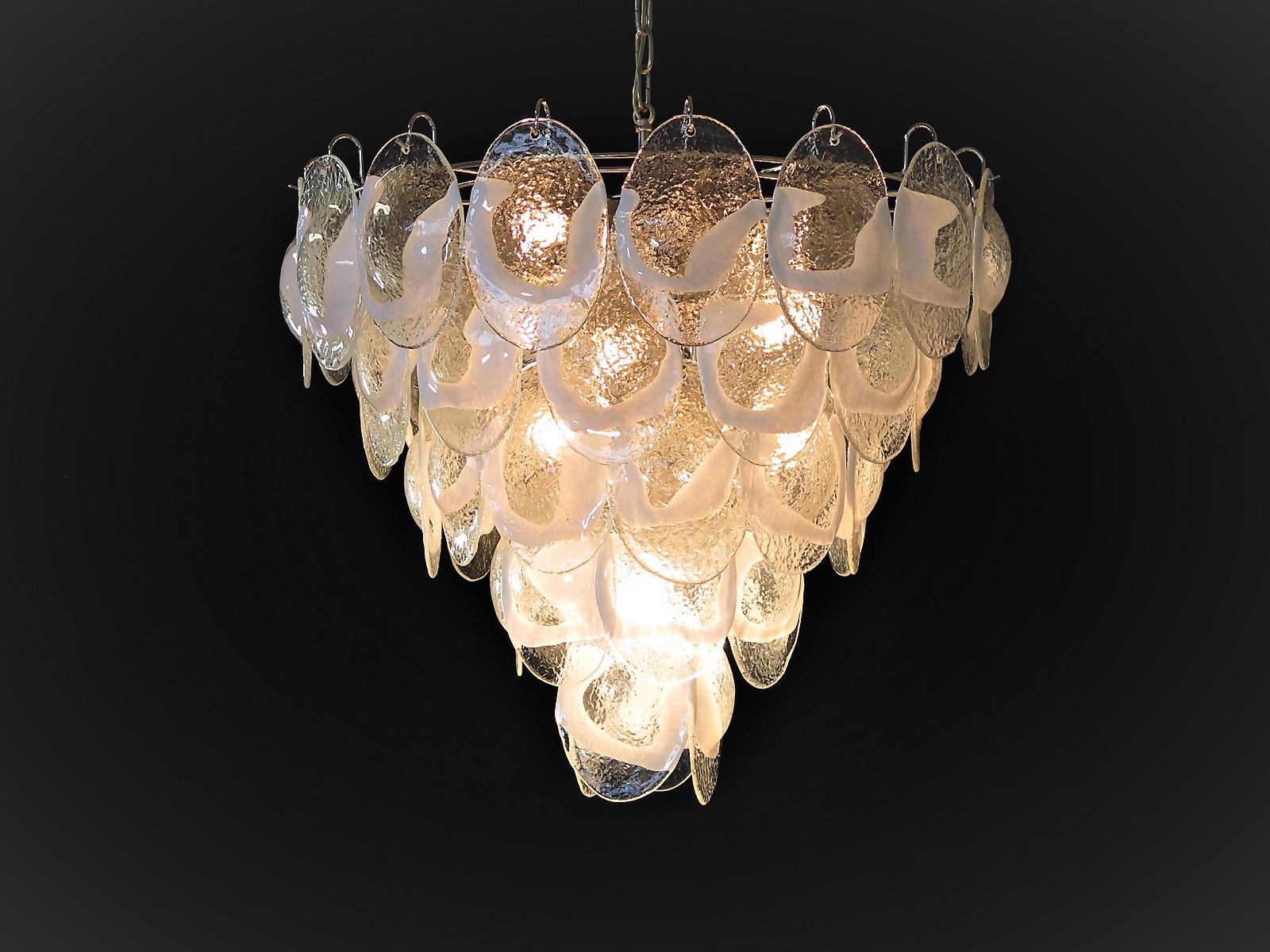 Pair of Italian vintage Murano chandeliers made by 51 glass leaves in a chrome frame. The originality of this chandelier is given by the glass, wonderful works of art transparent and lattimo, called shells. Murano blown glass in a traditional