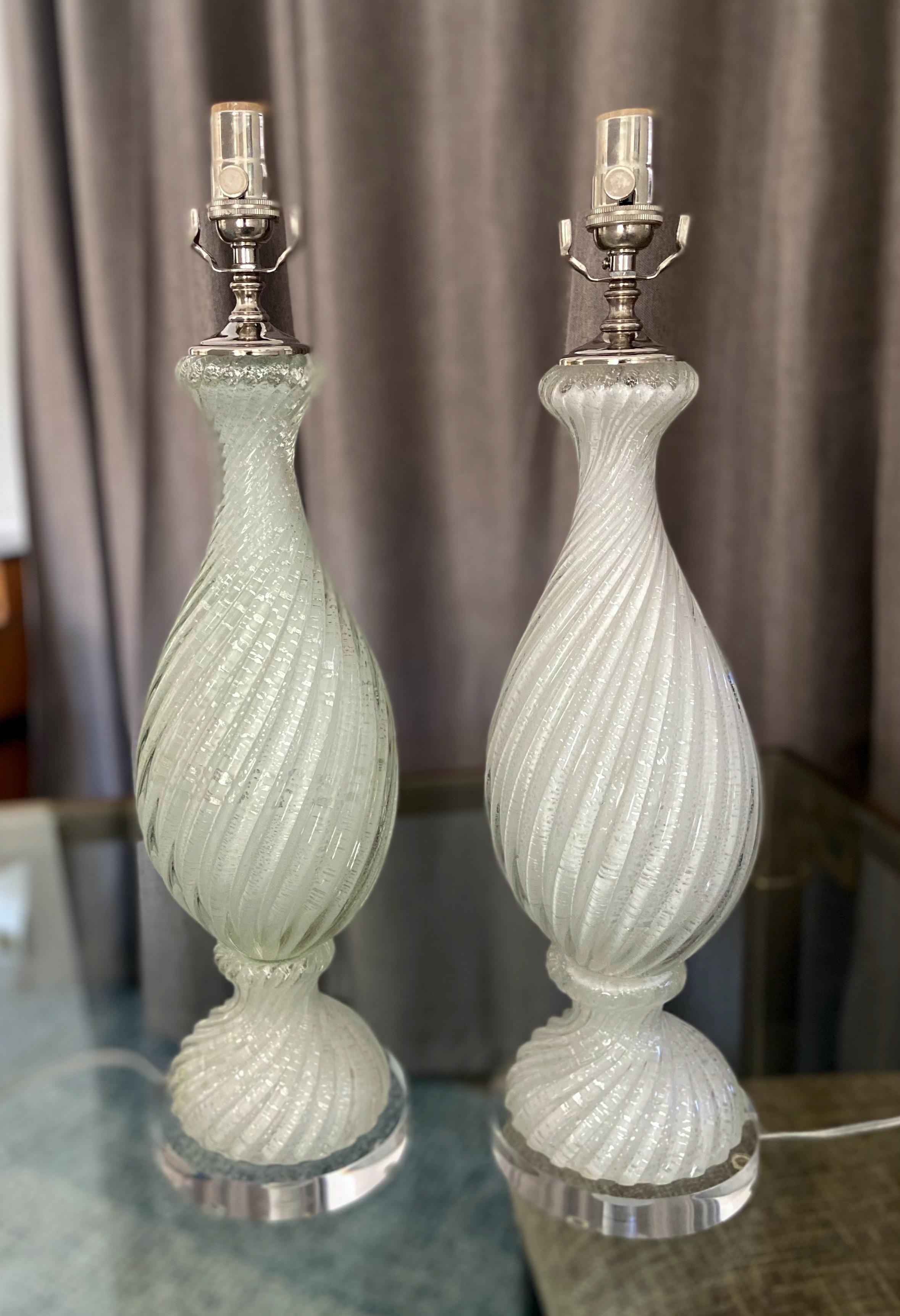 Pair of Murano Italian hand blown white twisted glass table lamps with silver mica flecks throughout on custom acrylic base. Rewired with new polished nickel fittings including new three way sockets and cords. This handsome lamp trikes the perfect