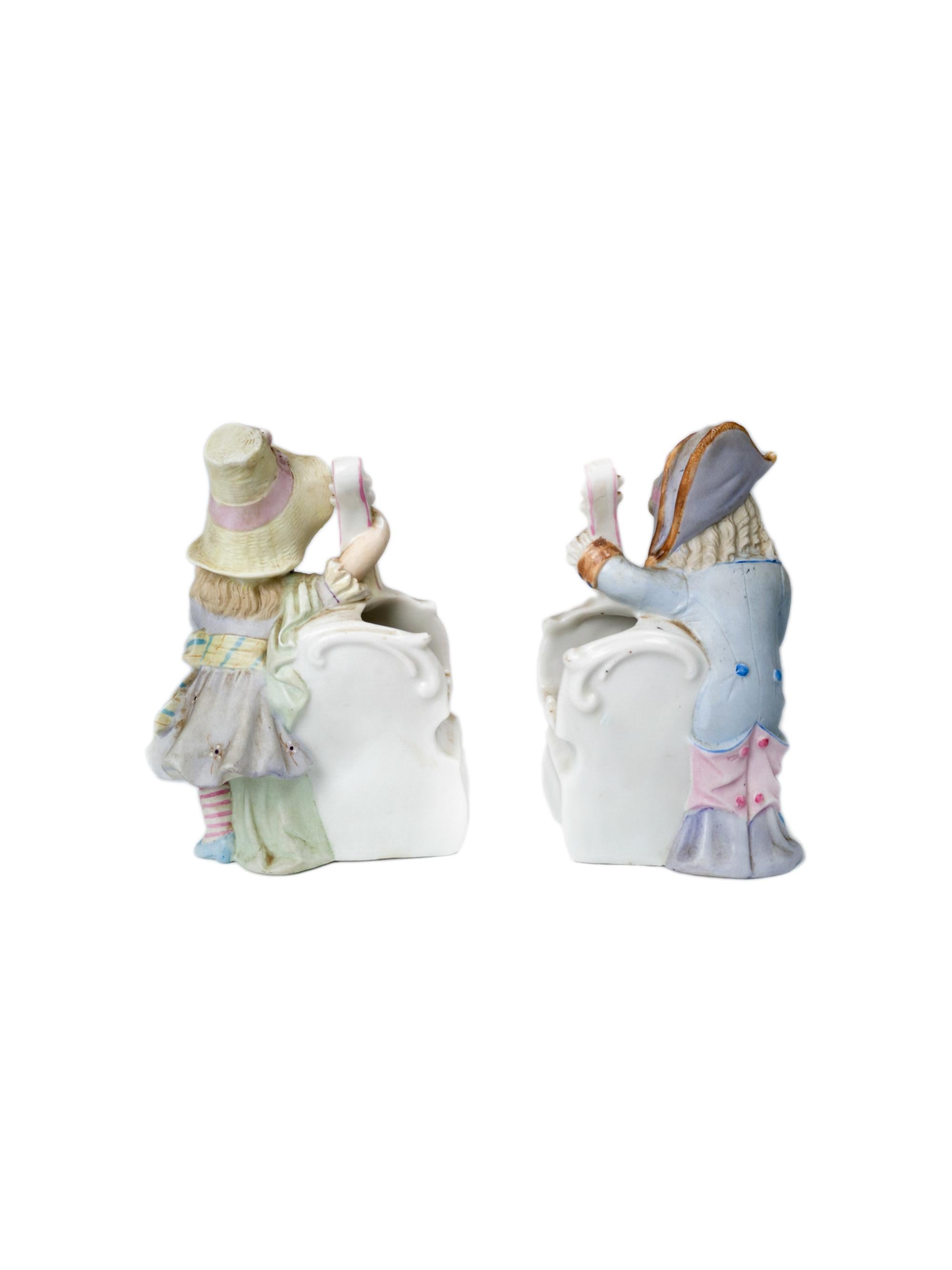 An antique pair of porcelain figurines vases of a couple of musicians cellists in pink and blue - in neutral timeless palette.

Pieces by Heubach brothers from Lichte, in Thüringen Germany
DEP mark on the base and several other marks and numbers in