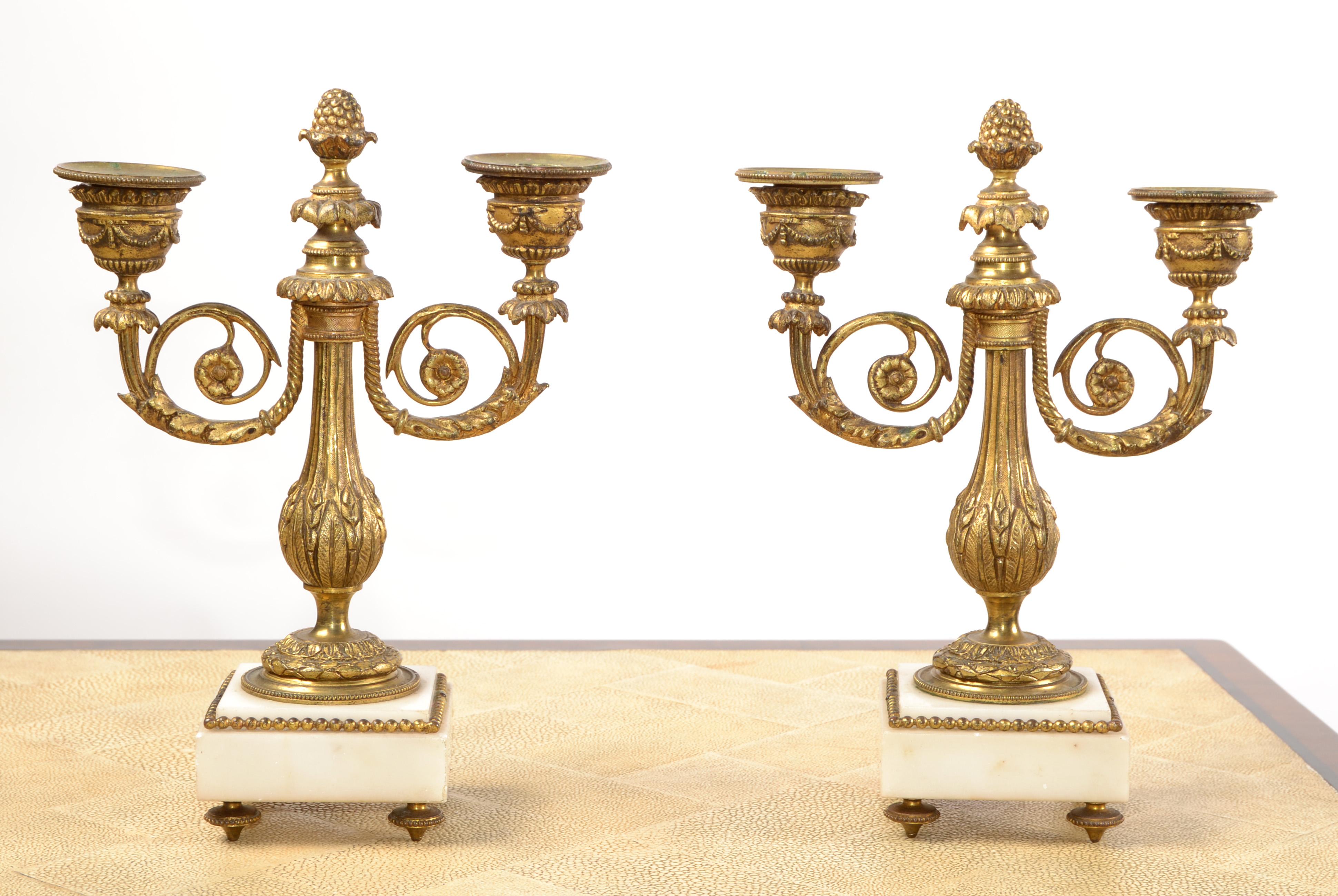 A pair of heavy Napoleon III Gilt Bronze and white Marble candleholders or candelabras.
Tarnished due to age and use some minor chips to the white Marble.
Base measures: 3.38 x 3.38 inches.