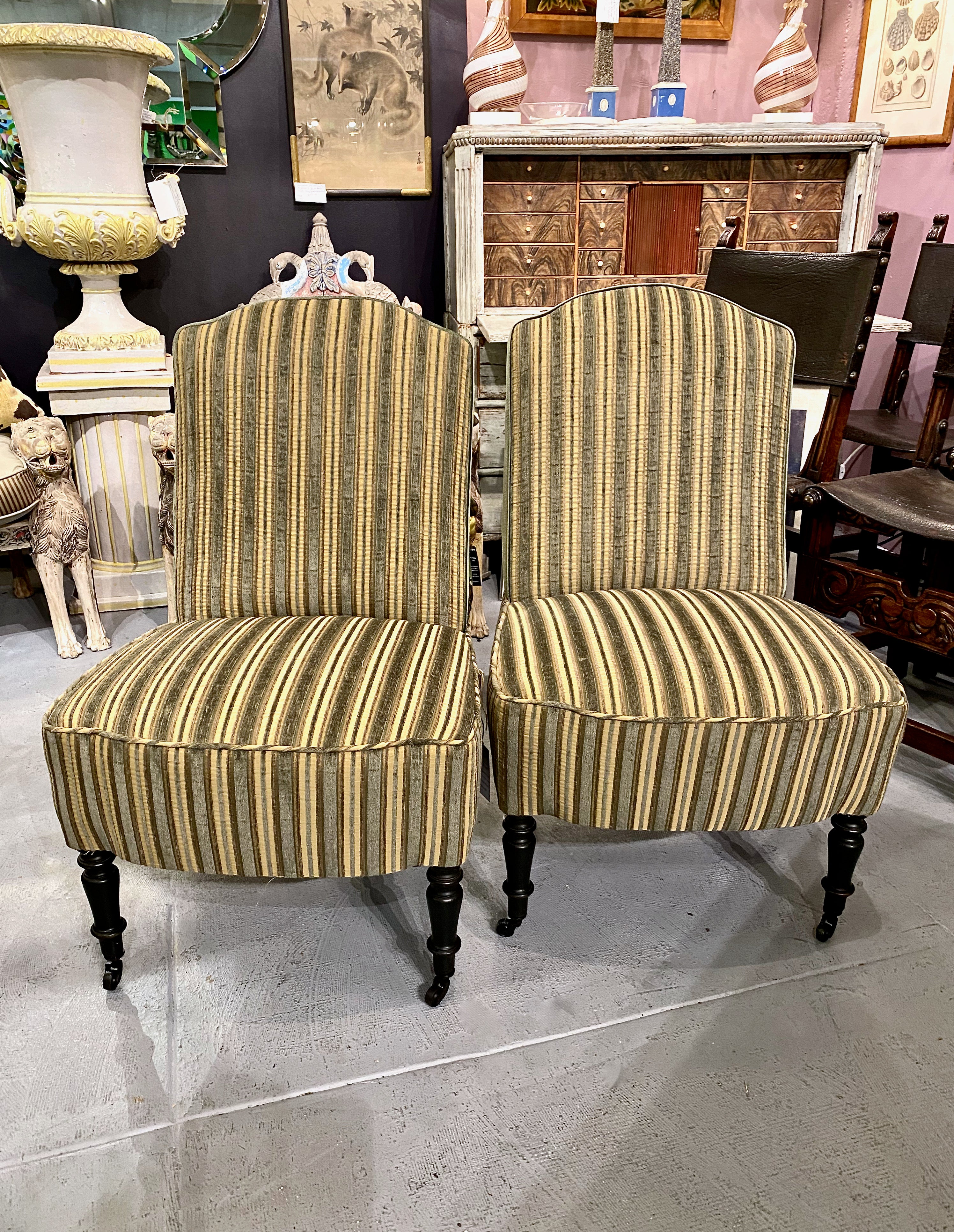 This is a superb pair of period Napoleon III Chauffeuses or Slipper Chairs that date to c. 1860-1875. The chairs feature arched back crests with tightly upholstered seats and backs. The chairs are newly upholstered in a high end Clarence House