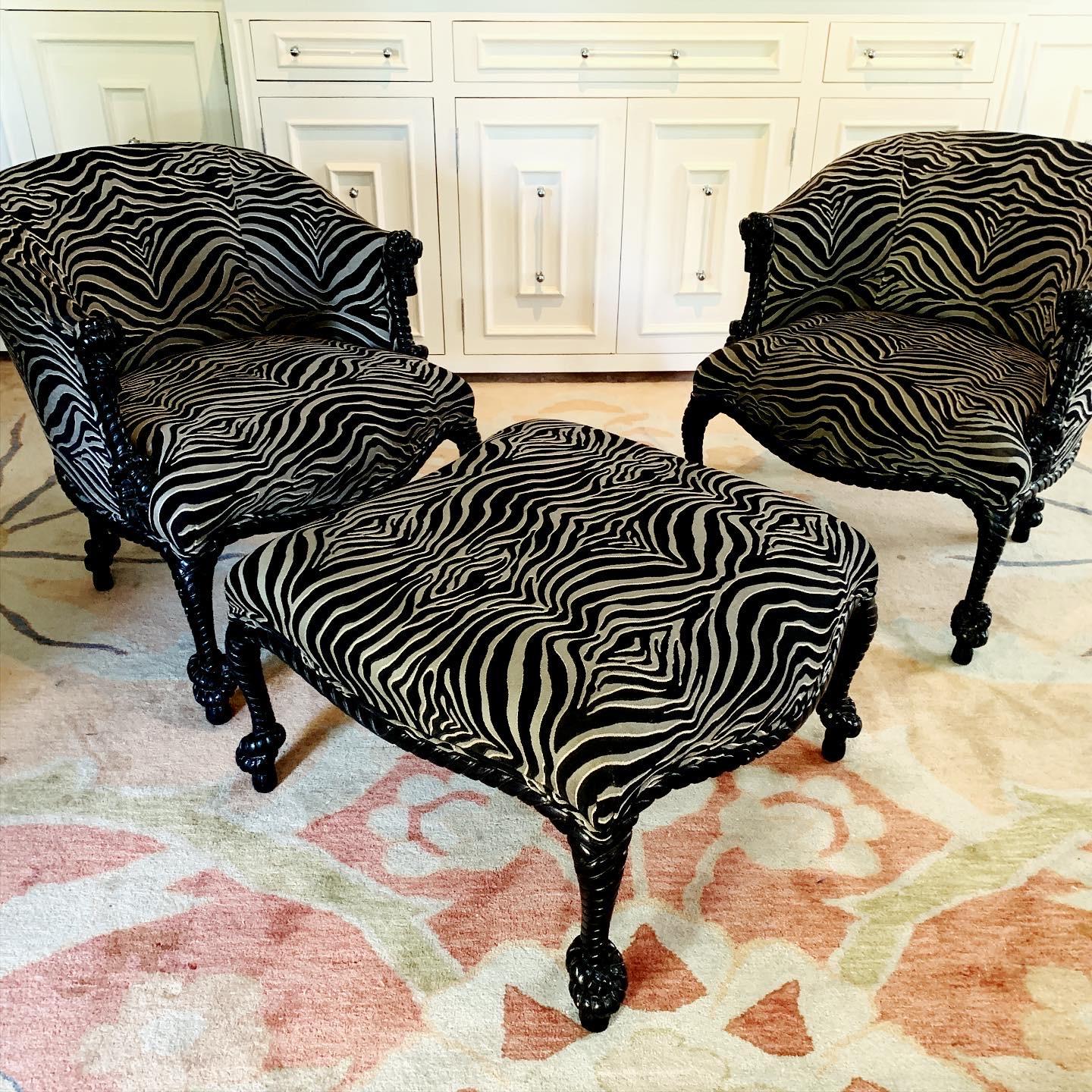 A rare pair of Napoleon lll carved rope and tassel chairs and matching ottoman by Weiman The frames are in black lacquer with zebra upholstery - all hand carved and in great condition. The ottoman is curved to easily place next to the chair creating