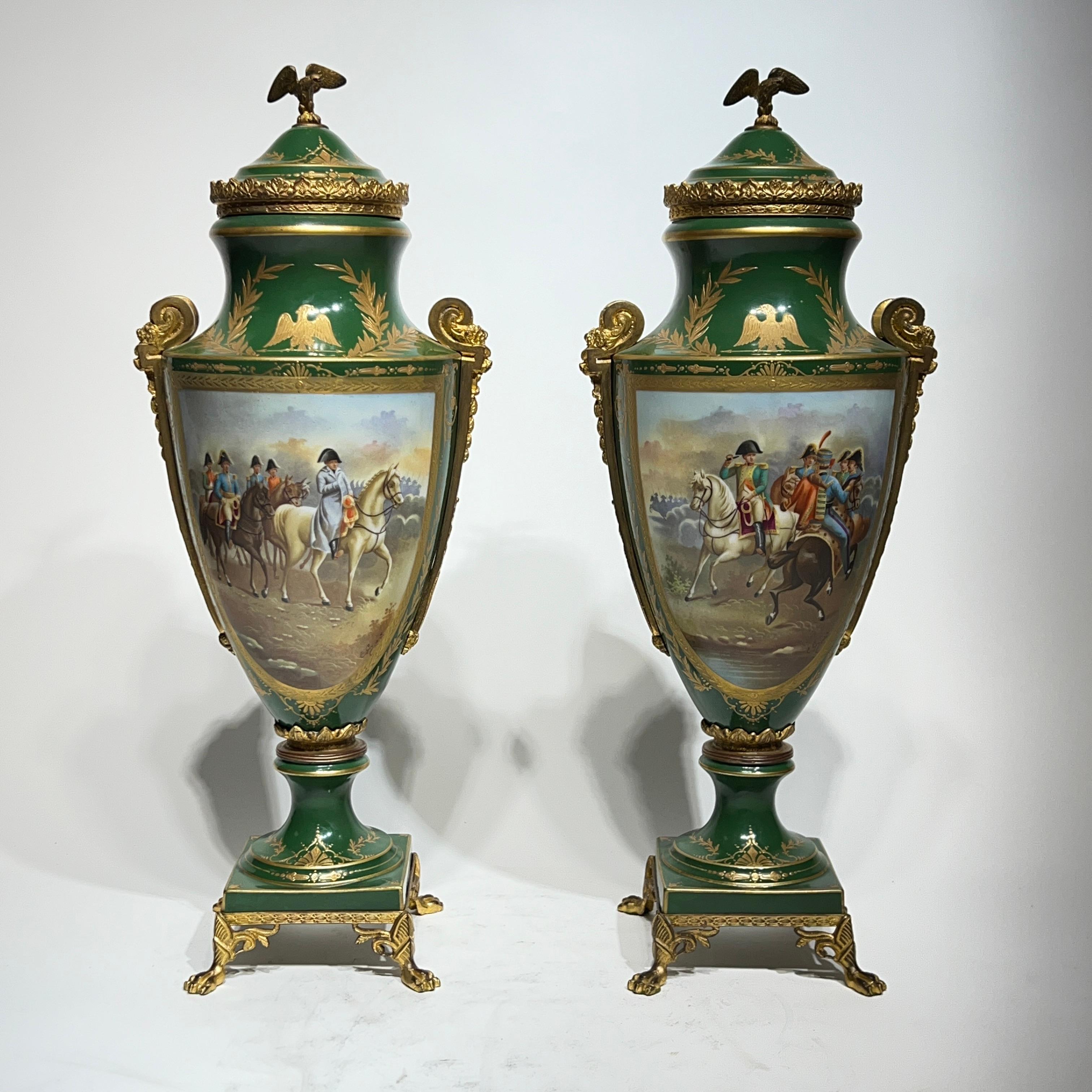 Pair of antique (early 20th century) porcelain vases with covers in the Sevres style, with gilt bronze mounts and well-painted scenes of Napoleon on the battlefield, with large cartouche on reverse depicting a mythical castle in the mountains.  Each
