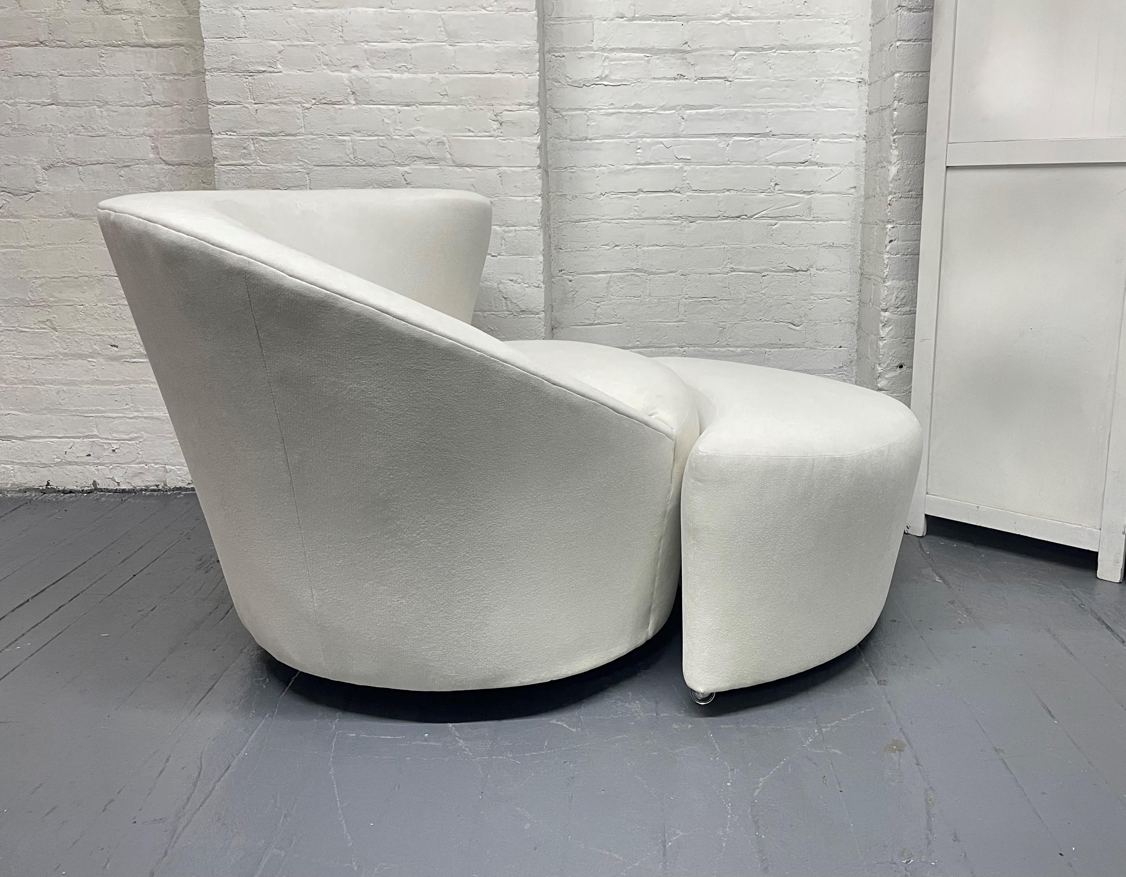Two pairs of asymmetrical swivel lounge chairs and matching ottomans. The chairs are in the style of the Nautilus chairs. The chairs and ottomans are newly upholstered. The ottomans have casters.

Chairs measures: 29 H x 34 W x 34 D.
Ottomans
