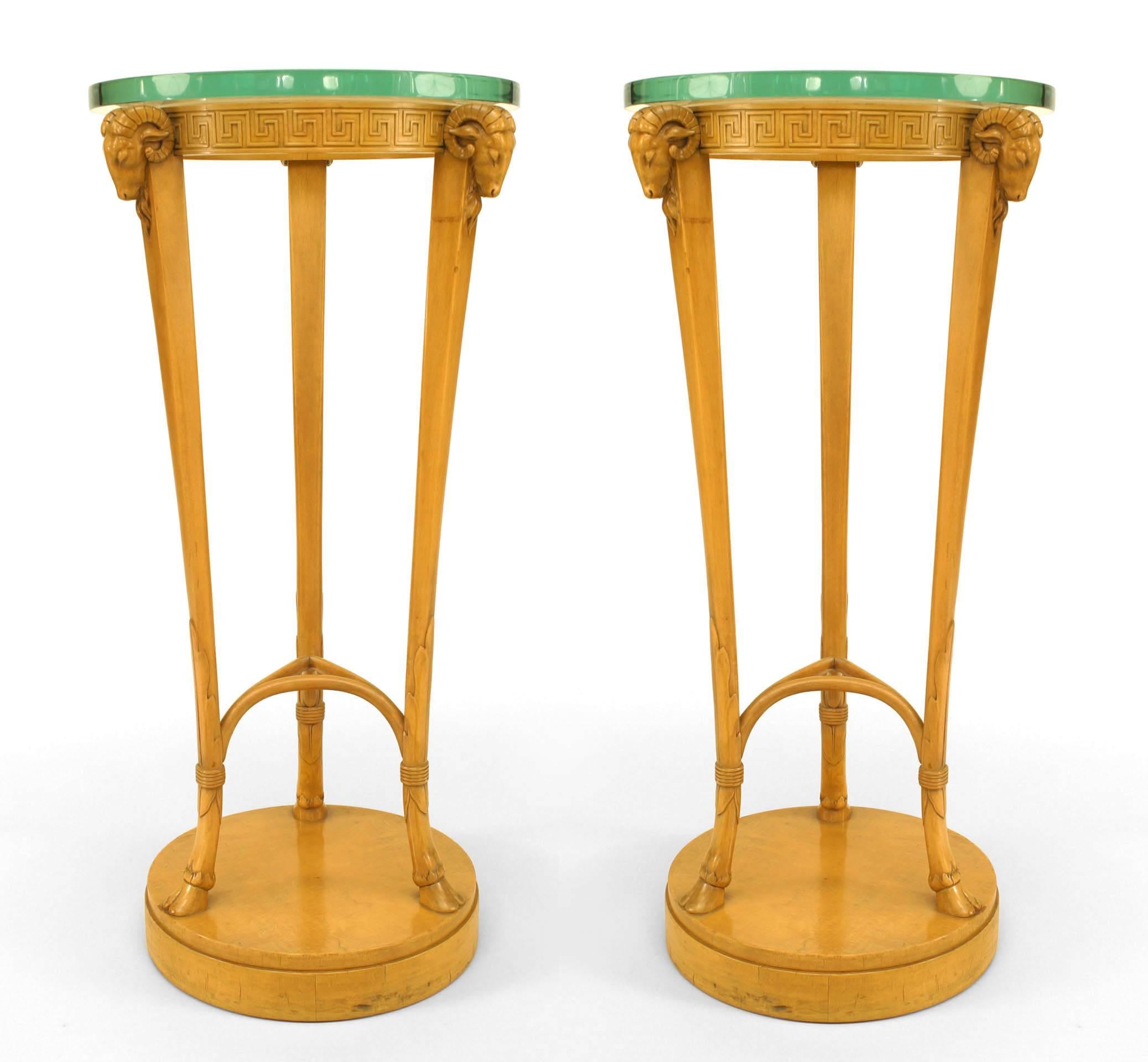 Pair of American Art Moderne sycamore pedestals with 3 ram heads and round glass tops above a Greek key apron with a stretcher and round base. (T. H. ROBSJOHN GIBBINGS)
