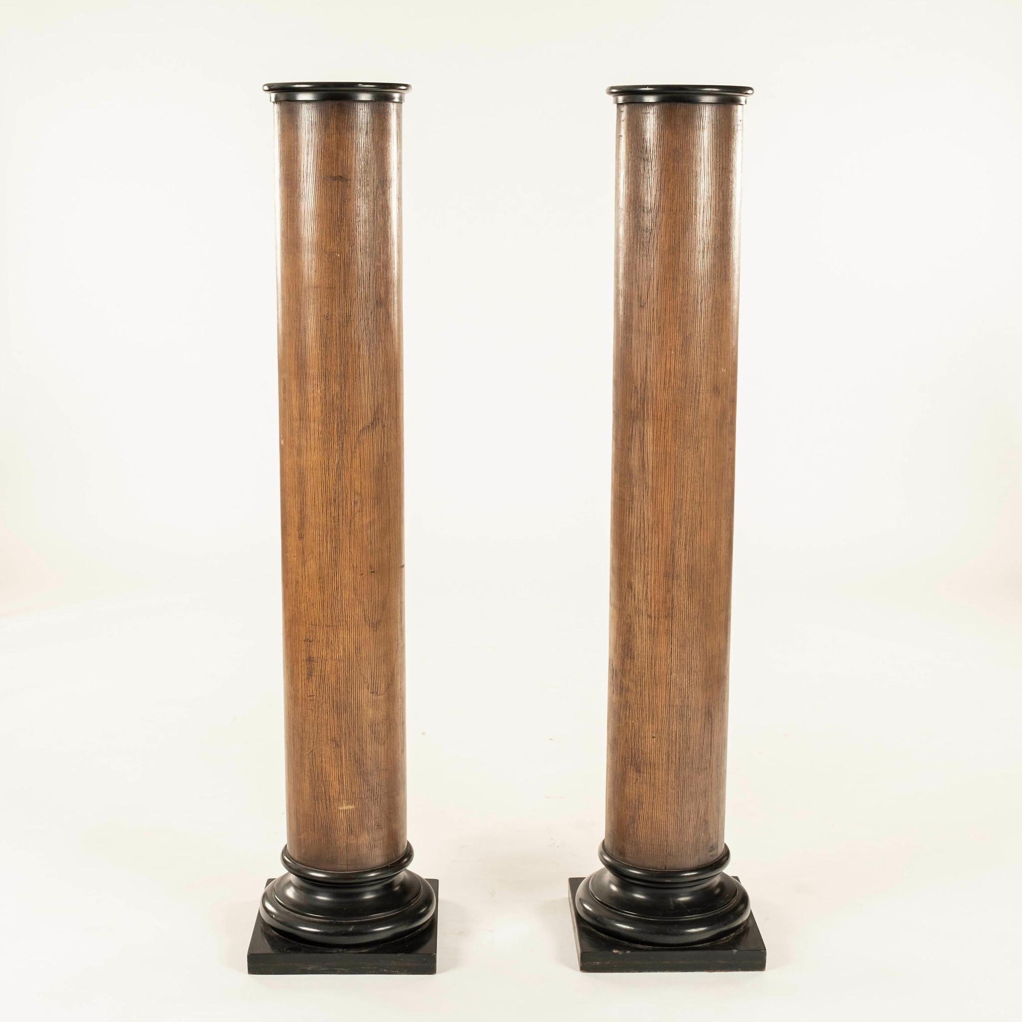 Pair of vintage Neoclassical Revival style column pedestals composed of painted wood featuring turned capital and base on a square plinth.