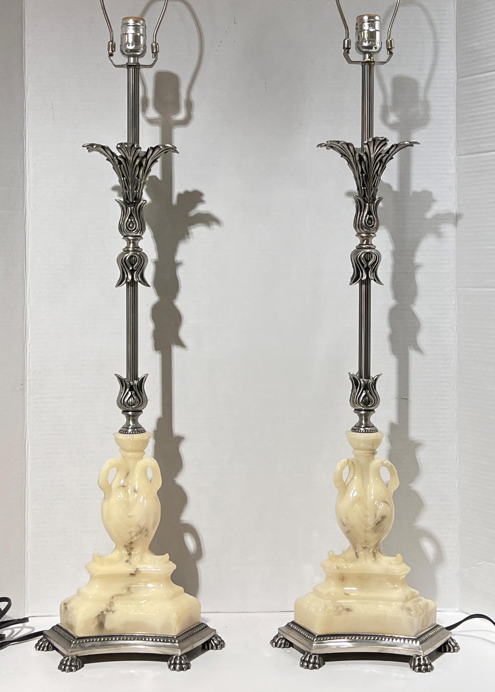 Pair of vintage silvered metal table lamps in the neoclassical style with molded composition  figures of swans.  Each in excellent condition.