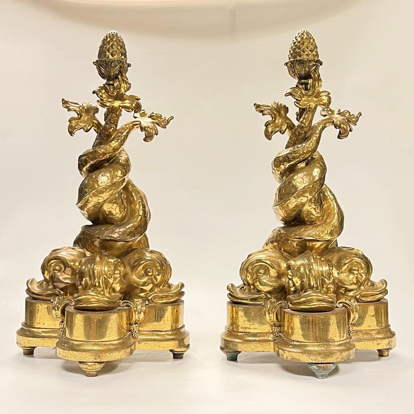 Pair Neoclassical Style Dolphin Form Gilt Bronze Chenets, distinguished by their monumental scale and casting.