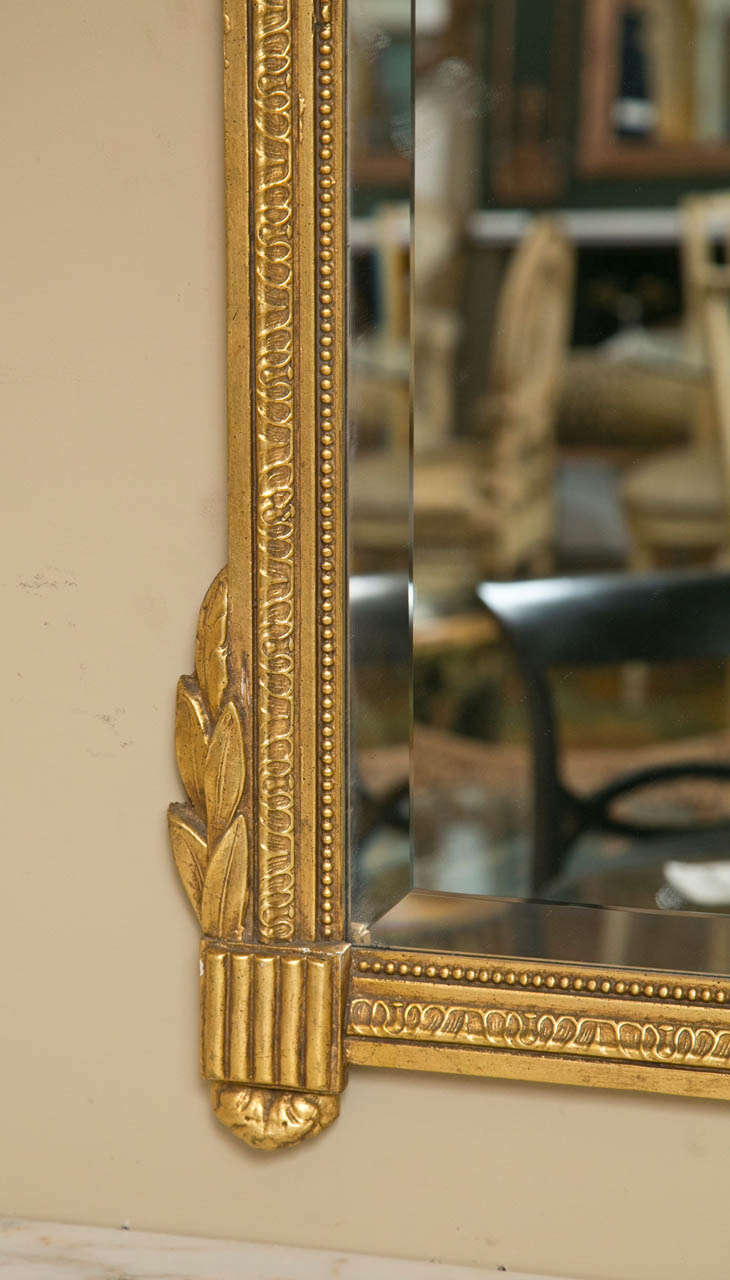 Neoclassical Style Giltwood Beveled Mirrors Decorated Urn Crest and Foliage Pair In Good Condition In Stamford, CT