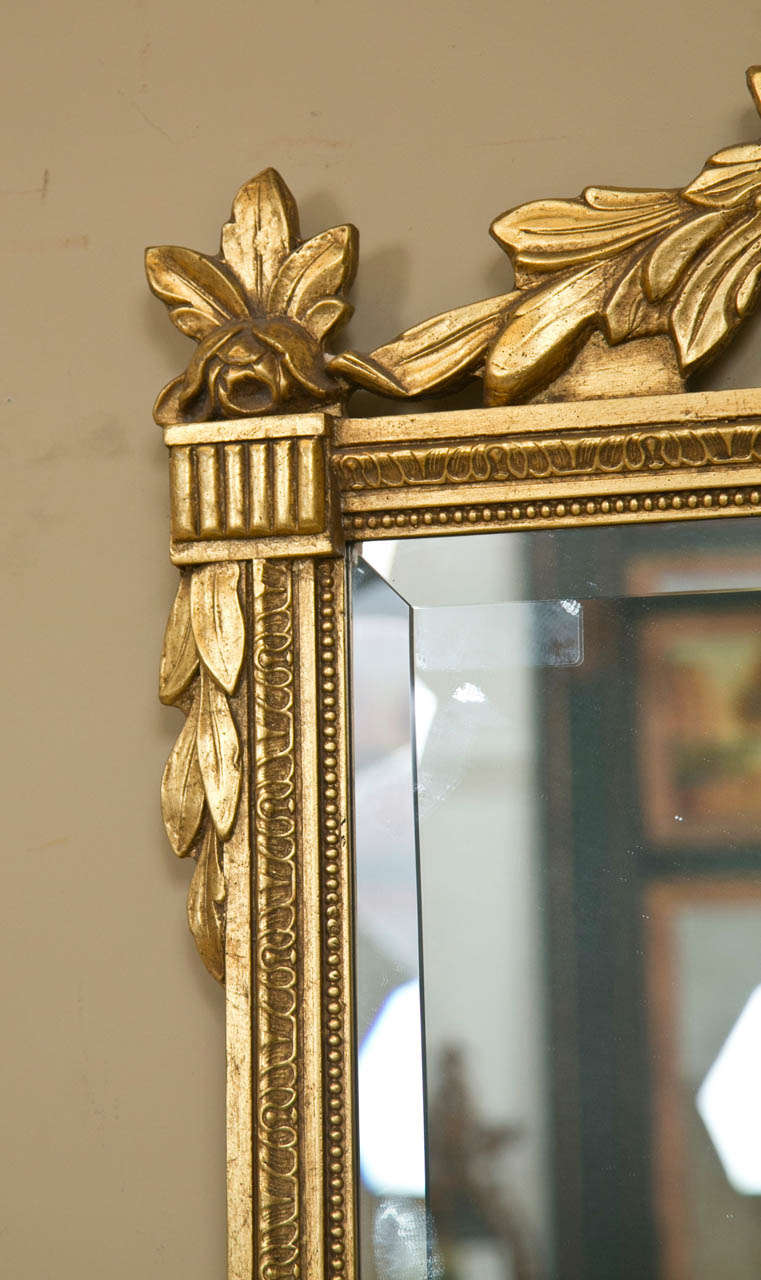 Mid-20th Century Neoclassical Style Giltwood Beveled Mirrors Decorated Urn Crest and Foliage Pair