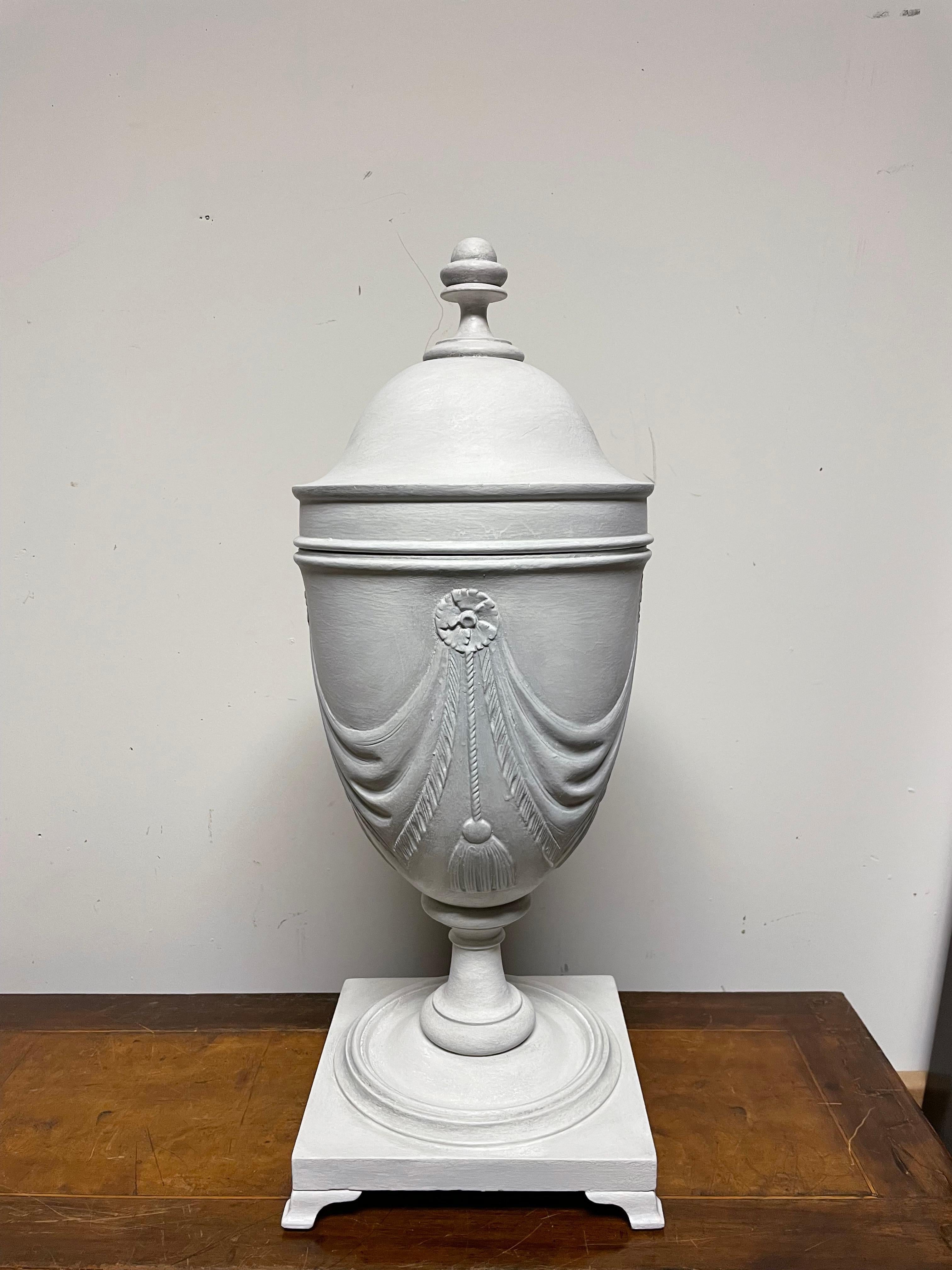 Very decorative pair of mahogany urn form knife boxes with wonderful gray  white painted finish. Each urn with swag decoration and acorn finial. The top lifts to show interior originally fitted for knives. 
These are wonderful decorative additions