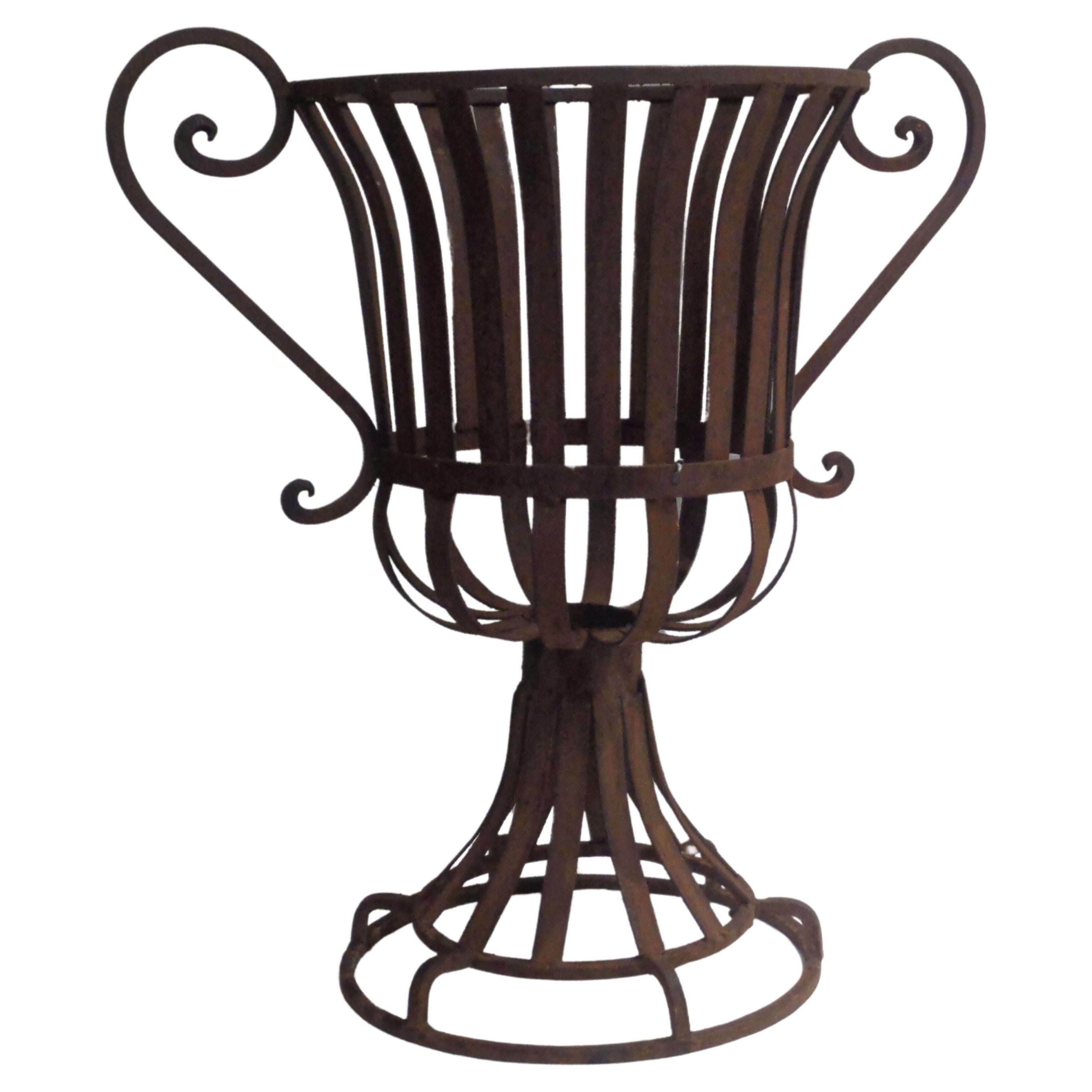 Pair of Neoclassical style strap iron garden urns with large decorative loop handles. Welded construction. Overall nicely aged surface. Small metal tag under one urn - Mexico. Measure 23
