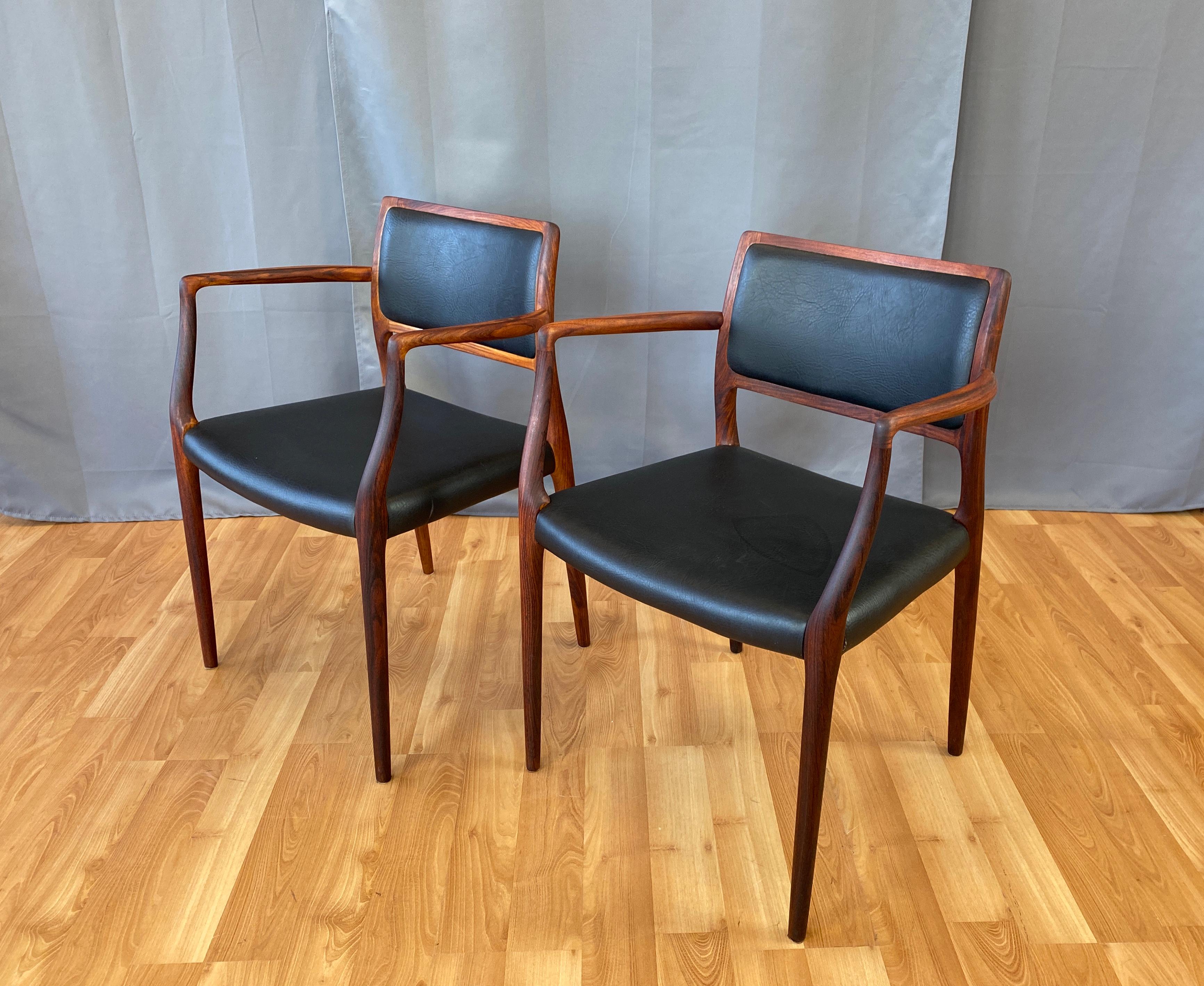 Offered are a pair of Niels Otto Møller model 65 armchairs, frames are rosewood, black upholstery is vinyl.