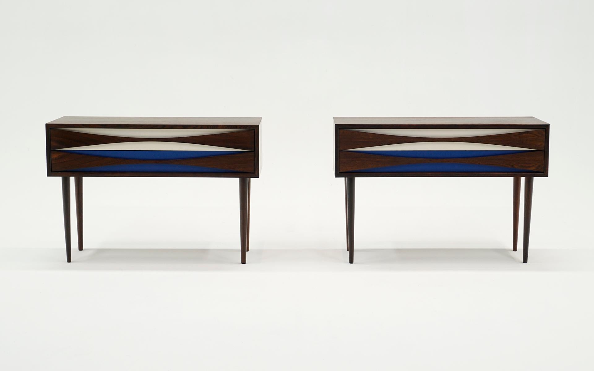 Pair of nightstands in Brazilian rosewood with blue and white drawer fronts designed by Niels Clausen, 1960s, Sweden.  Very good refinished condition and ready to use.  