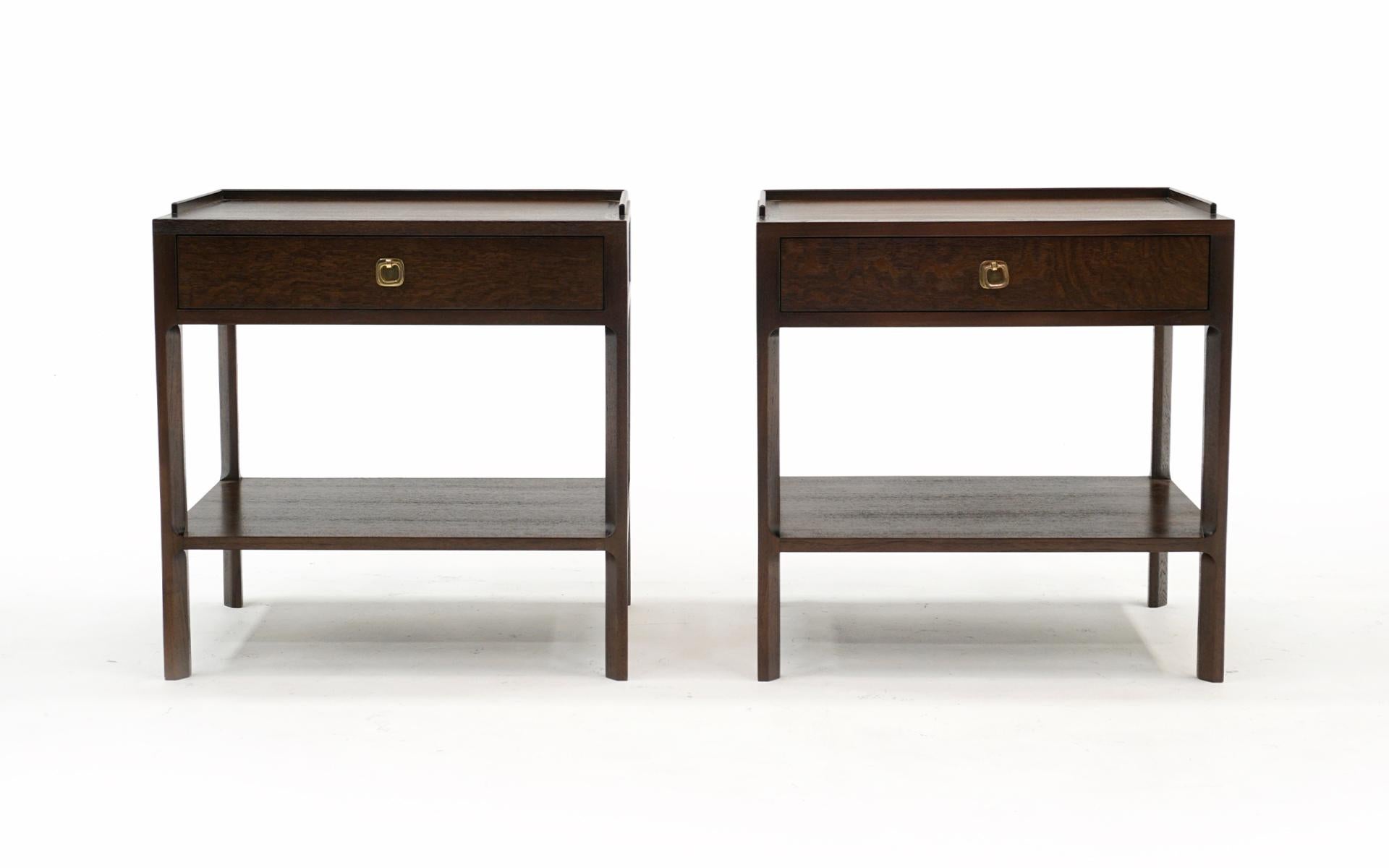 Pair of night stands / end or side tables designed by Edward Wormley and manufactured by Dunbar, 1950s.  Solid Teak sculptural frames with English Brown Oak tops and sides with the original brass pulls.  These materials are cost prohibitive today. 