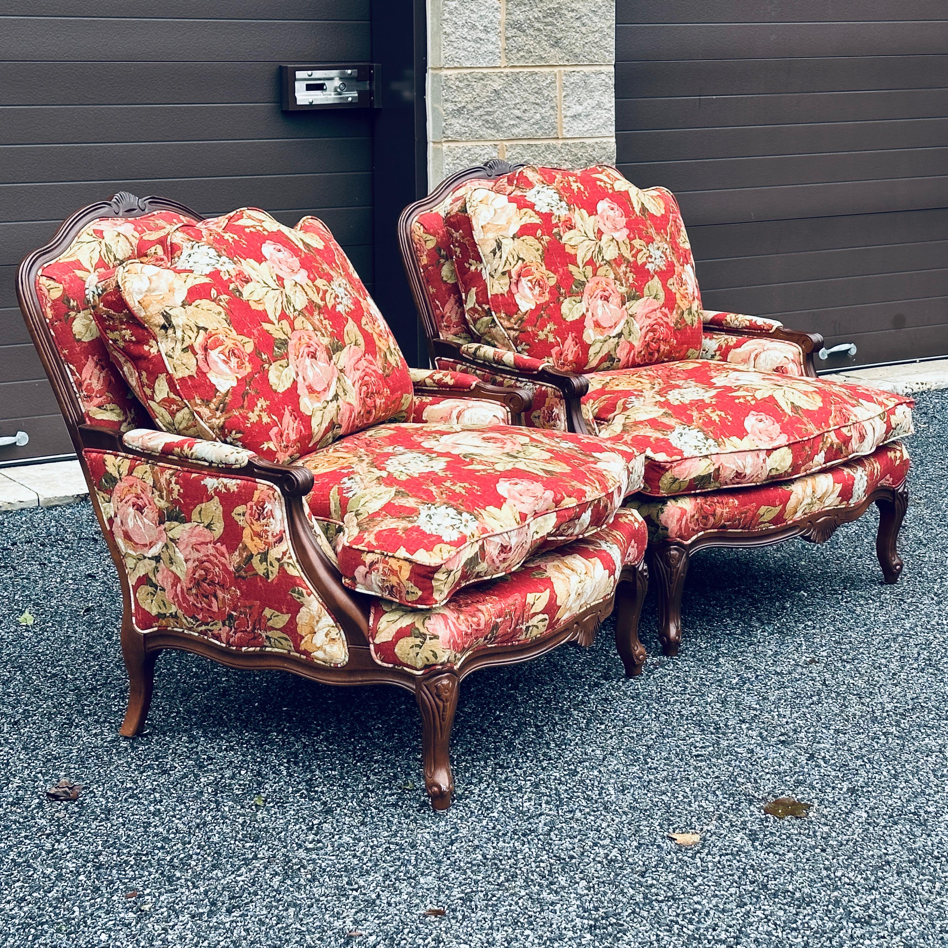 Pair of handcrafted in USA French style begere chairs by Norwalk Furniture with feather cushions and red floral upholstery.