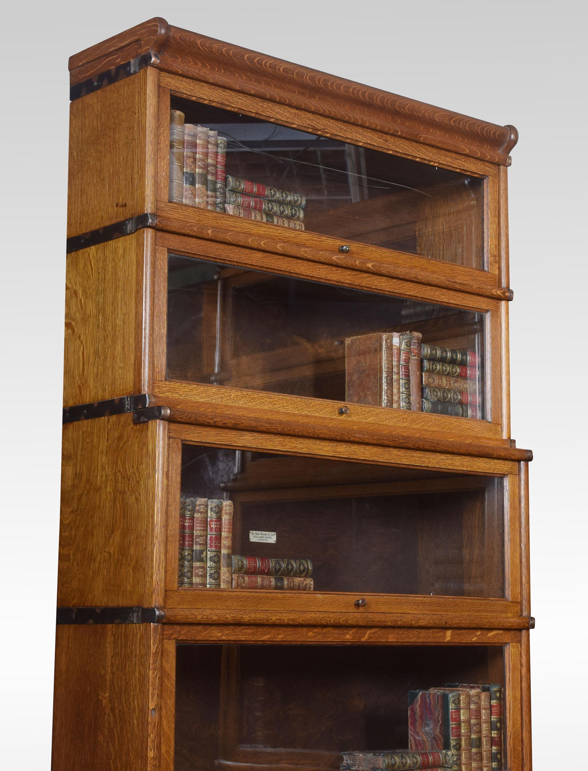 Pair of oak globe Wernicke six-section bookcases, the moulded top above six graduated sections all having glazed doors, raised up on plinth base fitted with a drawer.
Dimensions:
Height 88 inches
Width 34 inches
Depth 15 inches.