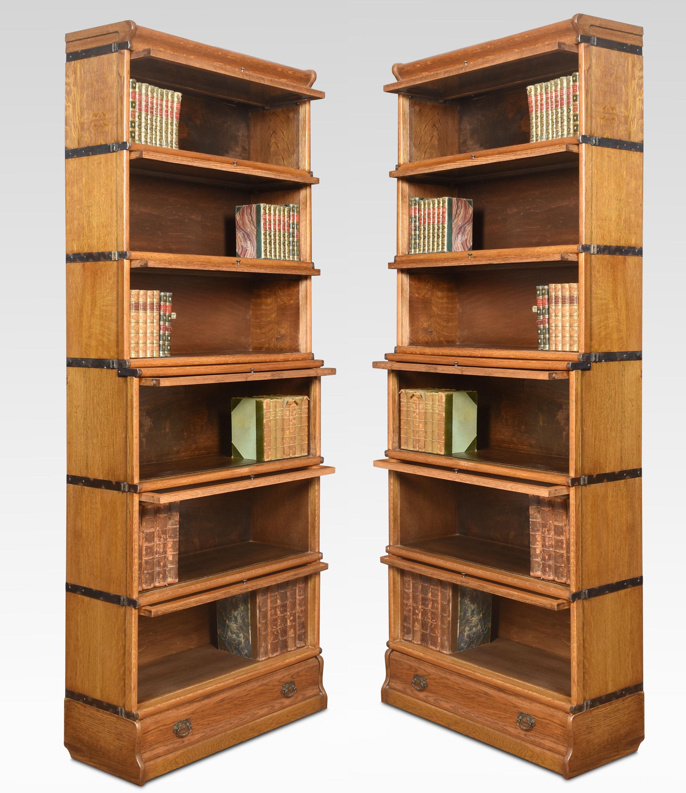 Pair of oak globe Wernicke six-section bookcases, the moulded top above six graduated sections all having glazed doors, raised up on plinth base fitted with a drawer.
Dimensions
Height 81.5 Inches
Width 34 Inches
Depth 12.5 Inches