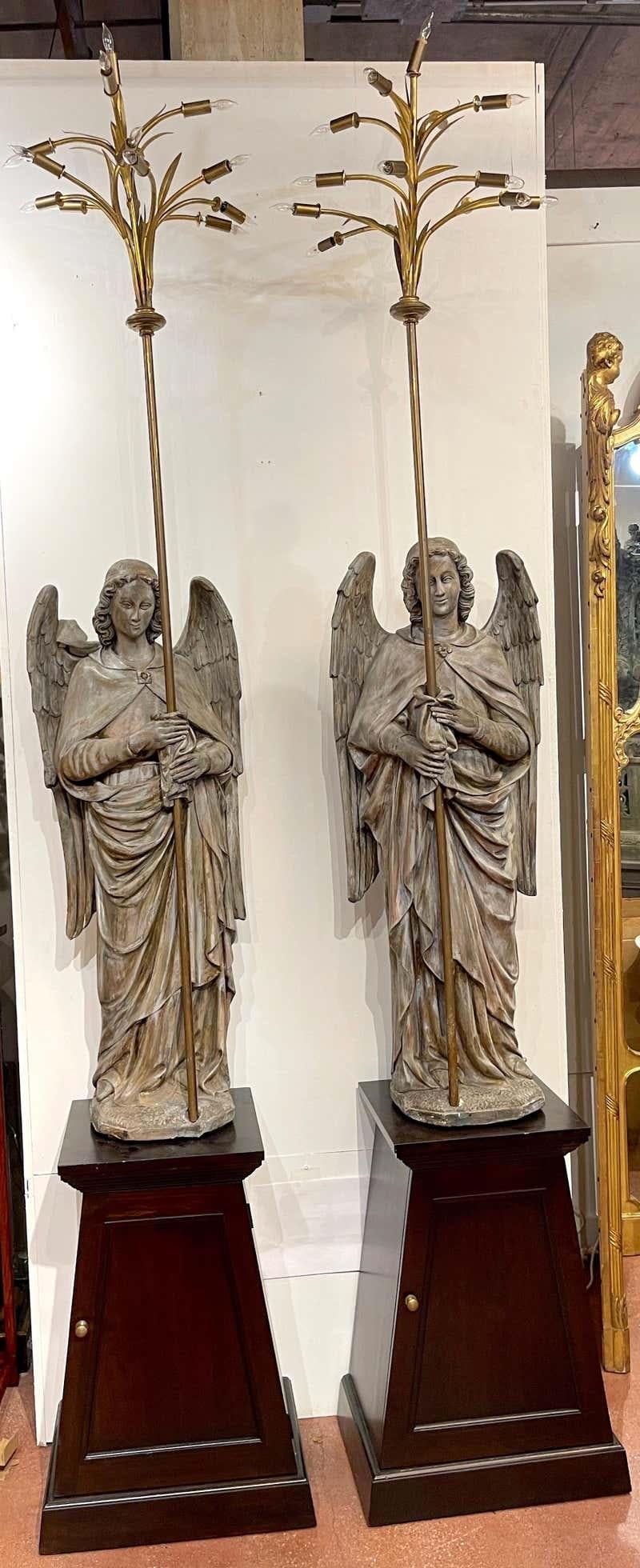 Pair of 12' polychromed plaster angel 14-light candelabra / lamps on pedestals
Subtle and dramatic, impressive in size and well executed.
Each angel stands 48