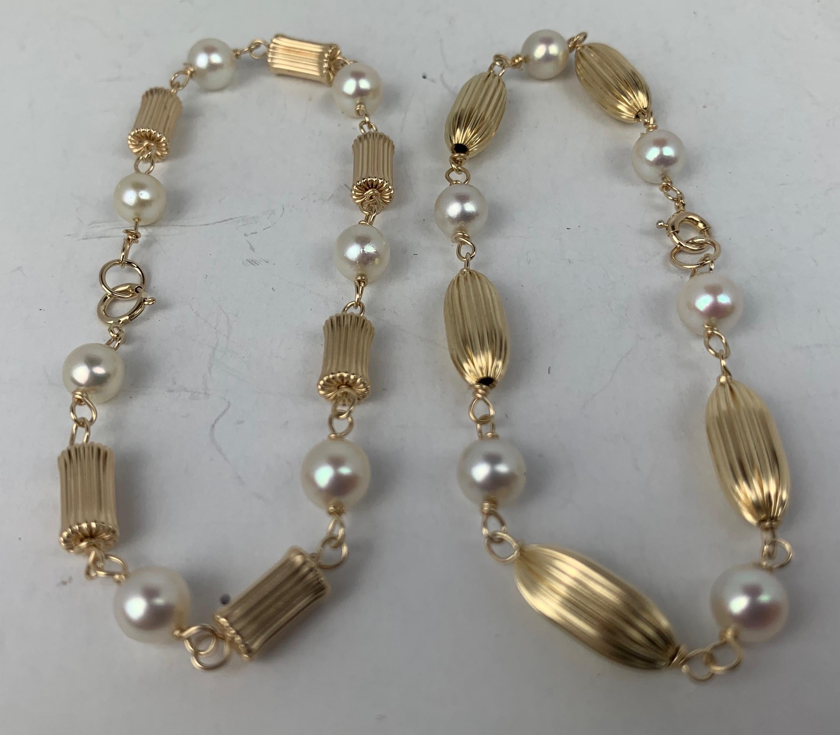 My client had this pair of bracelets custom made in the late 1950's.  She selected the gold beads and pearls and had her jeweler create them.  The fluted beads are 14k yellow gold, as are all of the parts and clasps.
Professionally cleaned and