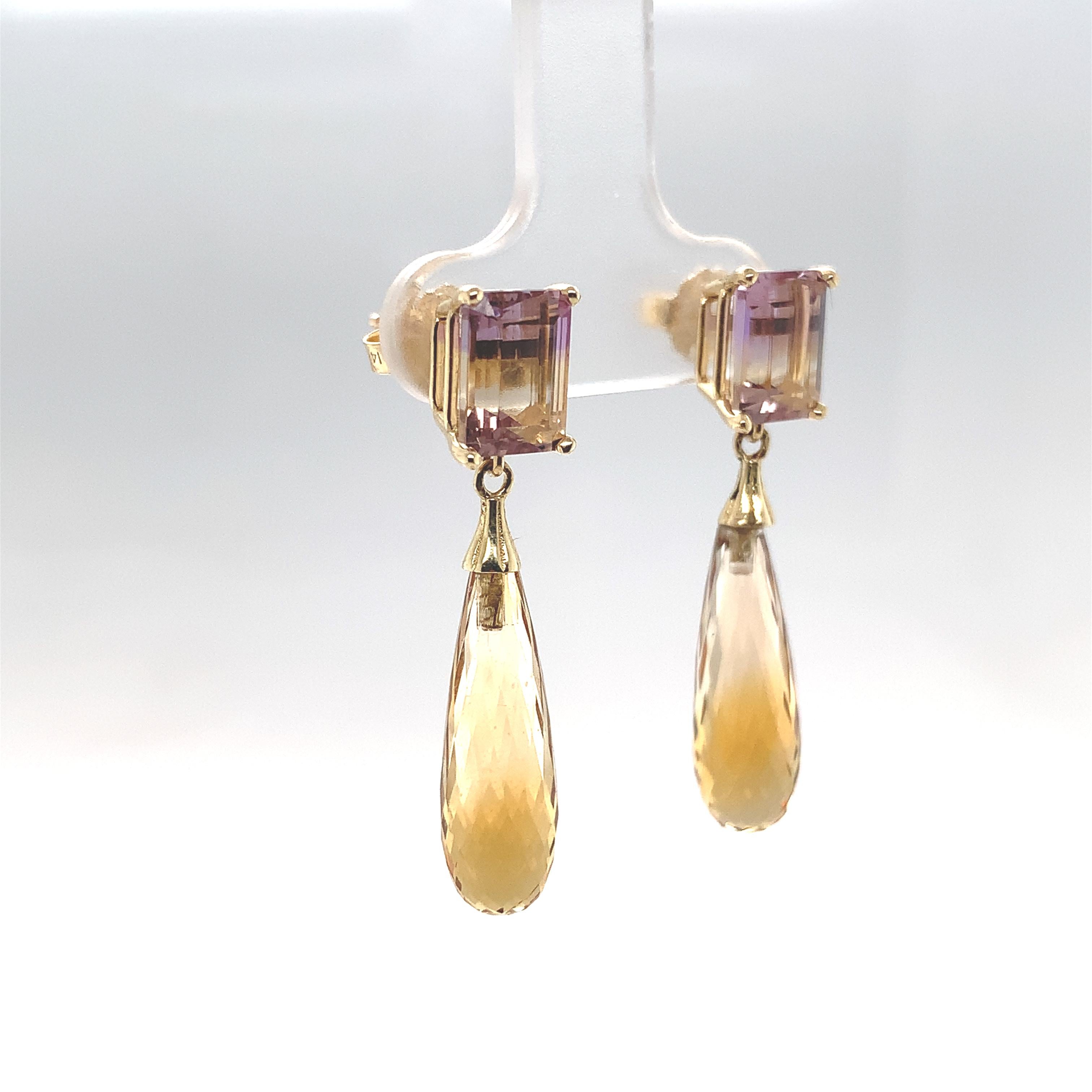 A pair of 14K yellow gold drop earrings with emerald cut ametrine and briolette citrine. The earrings have post with clutch backs. They measure 1 1/4