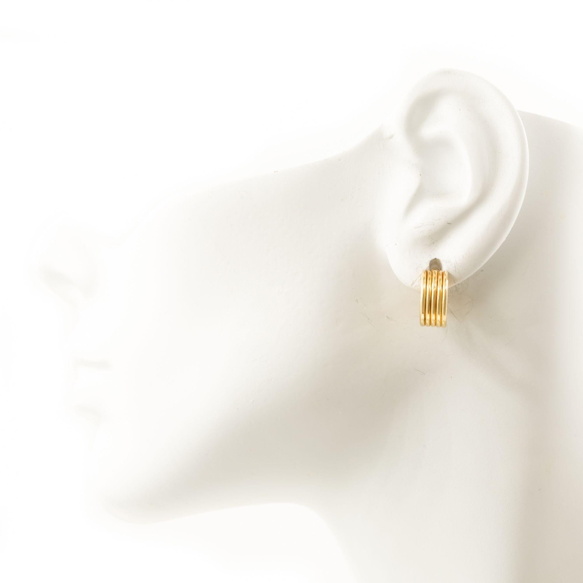 Pair of 14K Yellow Gold Ribbed Huggie Earrings
Item # C104604

A pair of 14 karat yellow gold huggie earrings with a ribbed design. These earrings are characterized by their small, hoop shape that 'hugs' the earlobe. The ribbed texture adds a