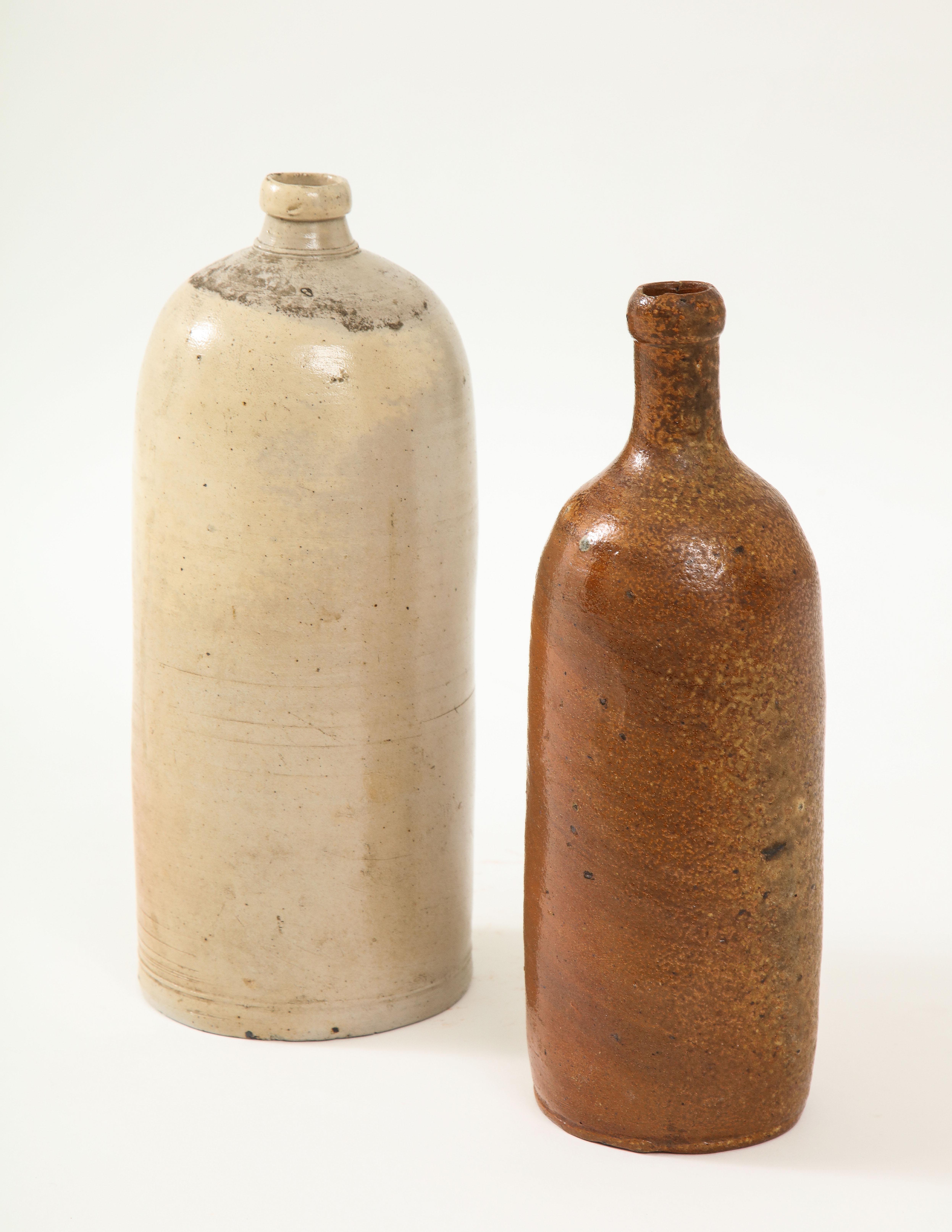 16th century and 17th century beer salt glazed stoneware jugs. One with charming small flower etched on the side along with a '2-1/2' measure note prior to firing.

Measures: Height 13, diameter 5 in.
Height 4 in.