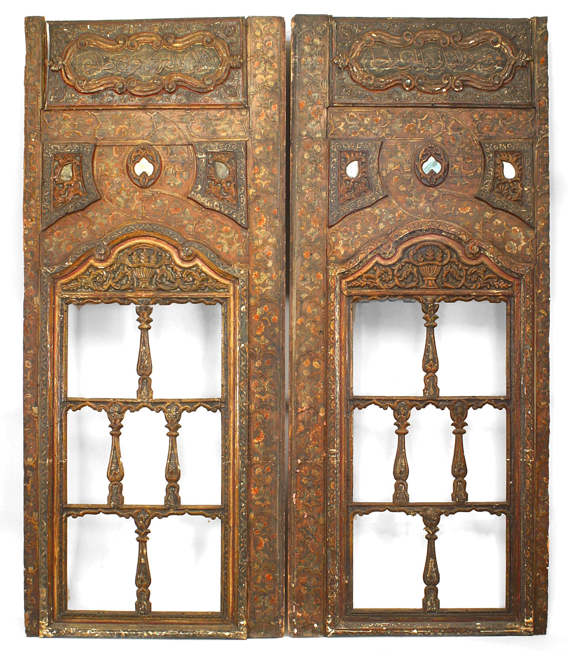 Pair of Persian (16th Century) carved and painted open design window panels with floral decoration.
