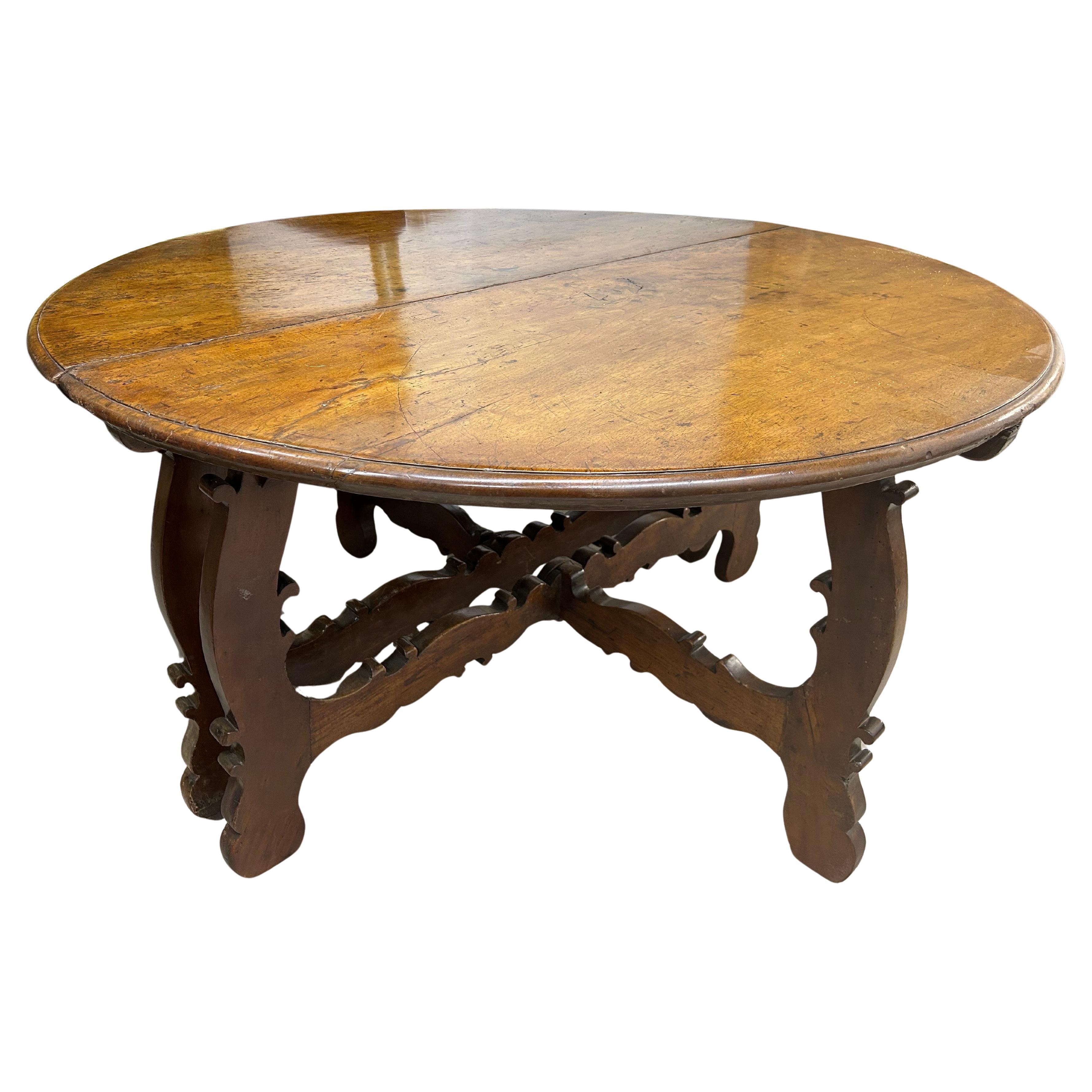 Pair Of 17th-18th Century Italian Console Tables.
Offered is an outstanding pair of late 17th to early 18th century walnut Tuscan console tables or demilune consoles that are stunning separated or joined to form a center table. Each table is raised