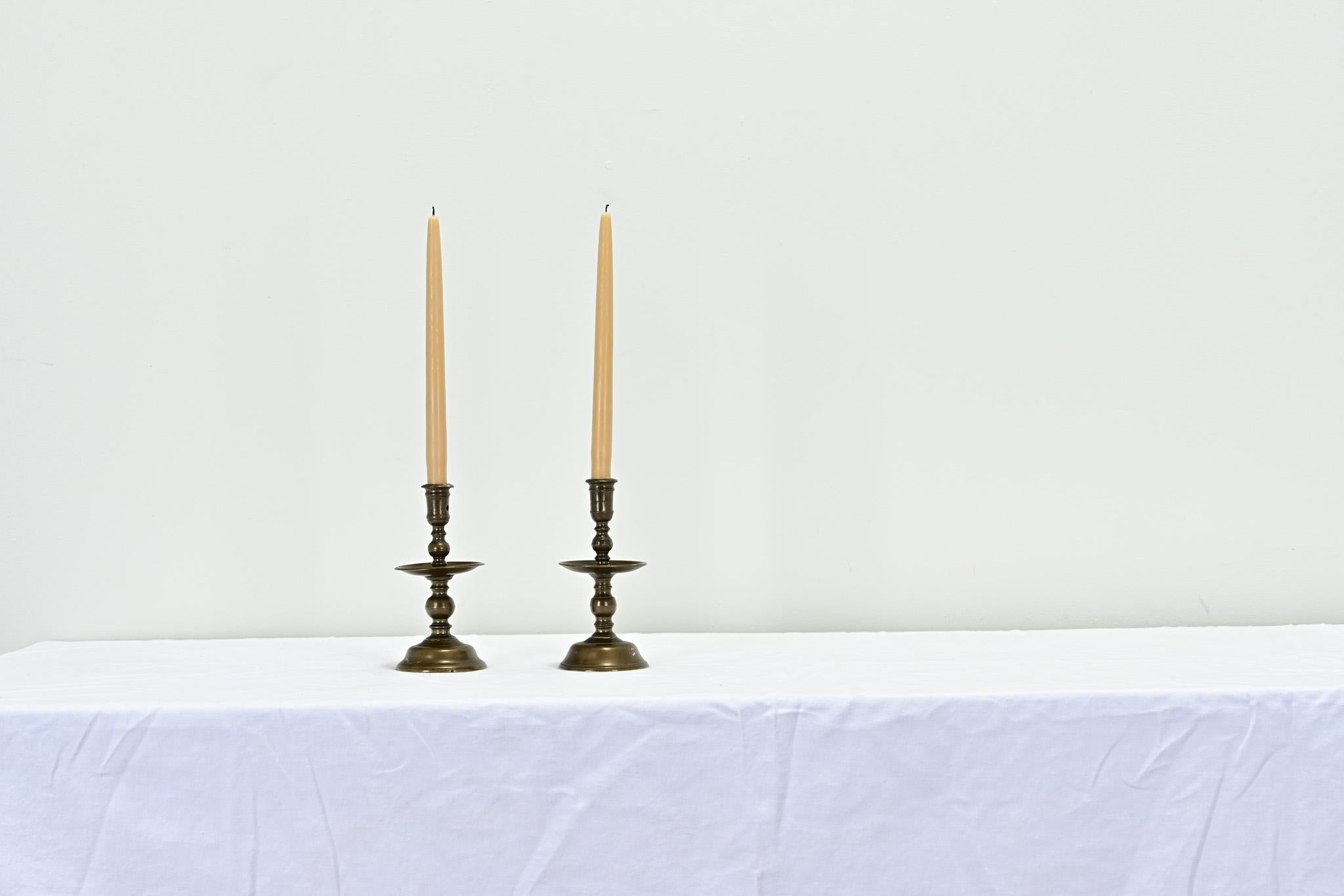 A pair of solid brass Flemish candlesticks from the 1600’s. This outstanding pair of candlesticks have stayed together for over 300 years. Be sure to view the detailed images to see the current condition. 