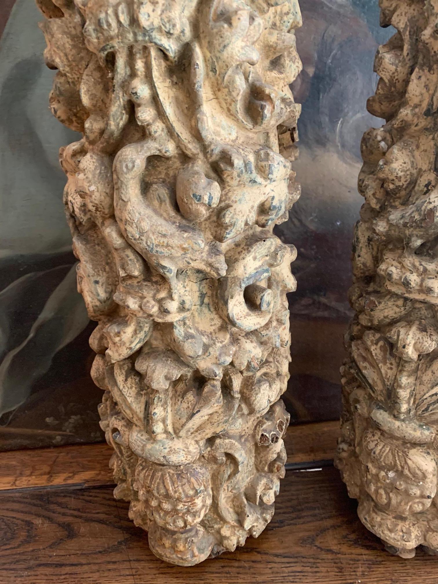 Pair of Portuguese polychrome columns with artisanal wood carving, the columns formed surely, part of a church altar, so in the back they present those cavities, to be able to attach them to a larger structure.
It preserves remains of white color