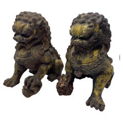 Pair of 17th Century Chinese Gilt Cast Iron Foo Dog Statues