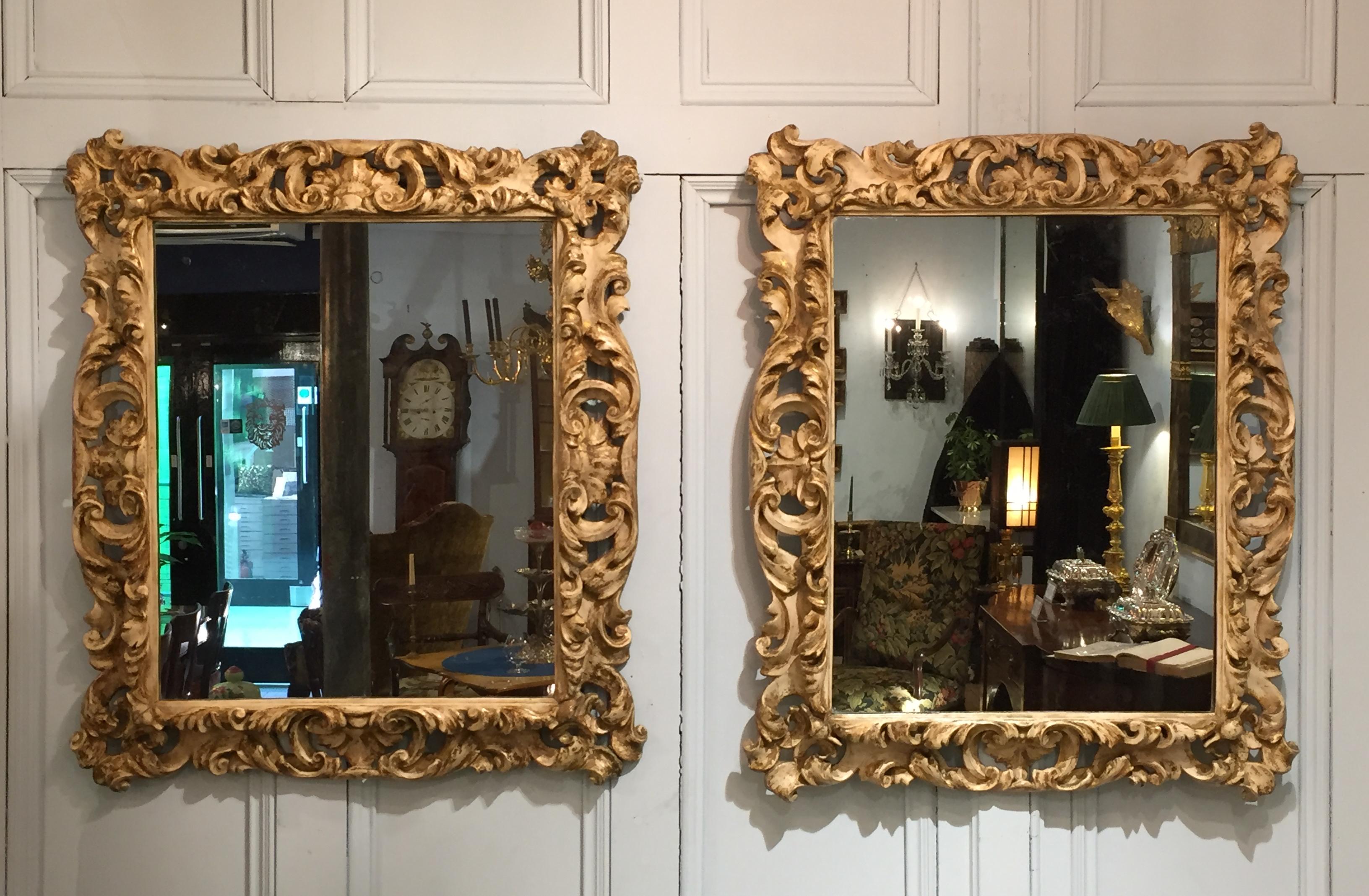 A superb pair of Carolean carved wood, gesso and parcel gilt frames. Originally to hold a portrait of a lady and a gentleman, later fitted with two 18th century mirror plates. The scrolling and stylized form is typical of the late 17th century