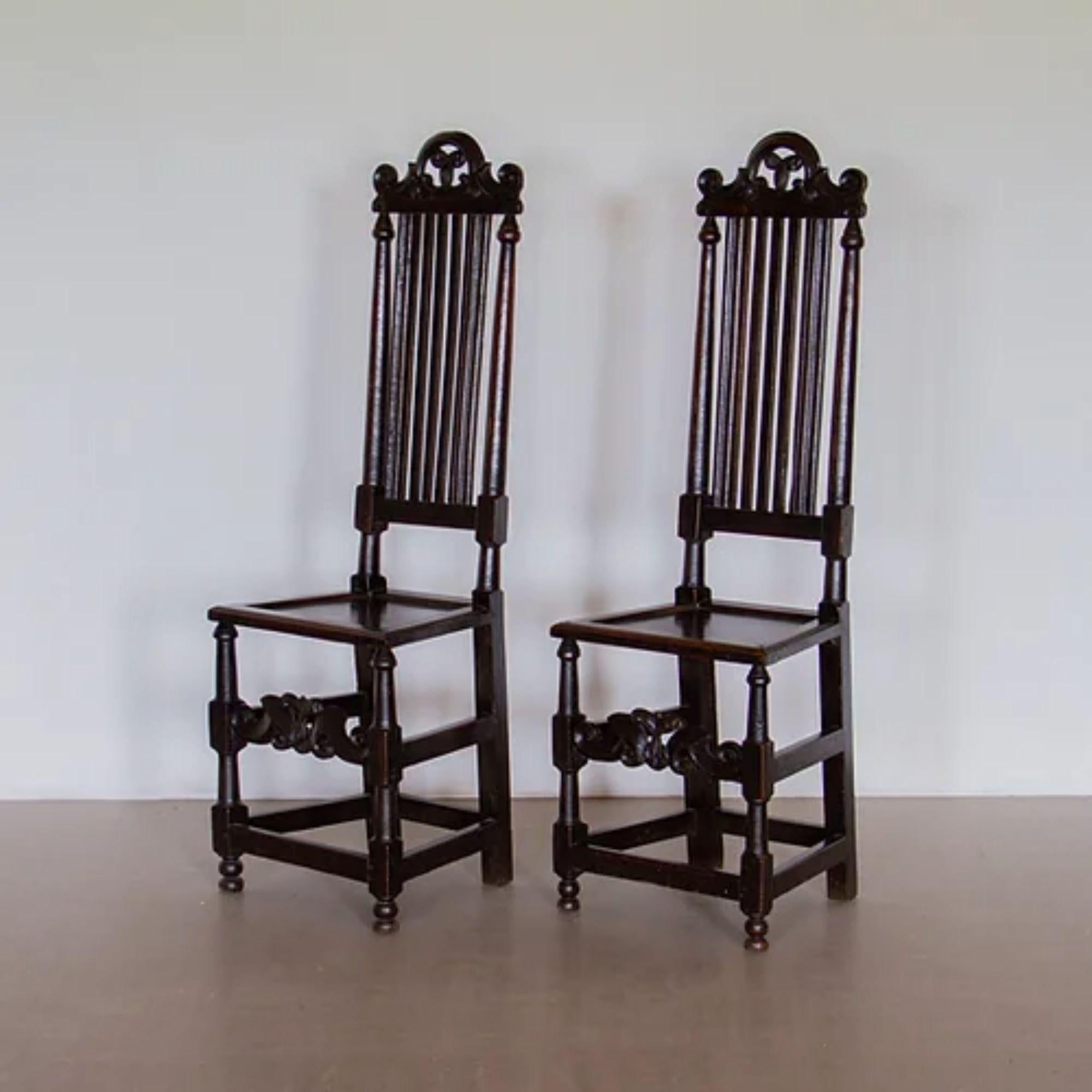 A pair of 17th century, James II, English oak, tall slat back chairs with carved scrolling detail to the back rest and seat stretcher, circa 1685

Additional information:
Material: Oak.
