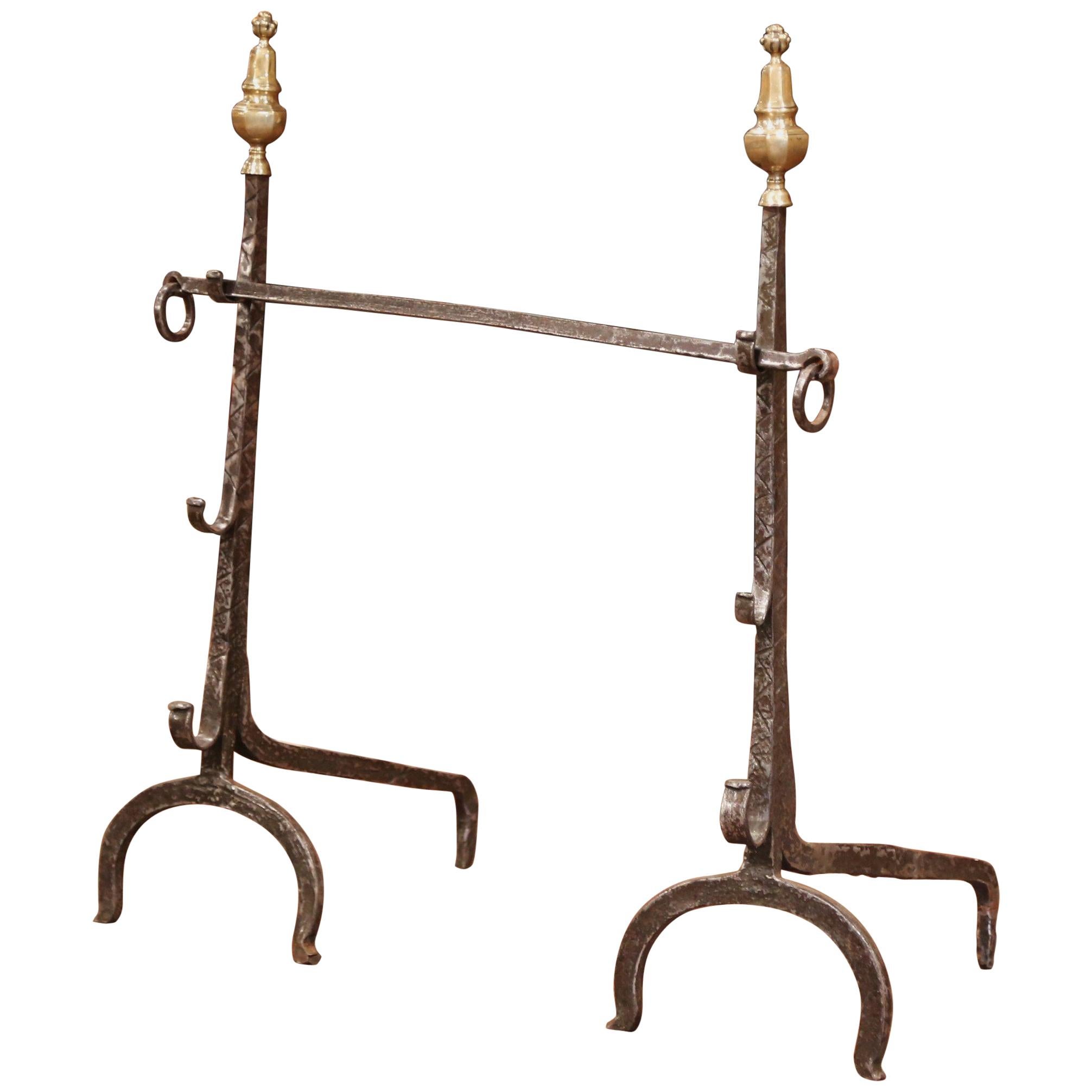 Decorate your fireplace with this tall pair of antique wrought iron andirons. Hand forged in France, circa 1680, the Classic Louis XIV fireplace essentials are embellished with decorative bronze finials at the top, and feature the original center