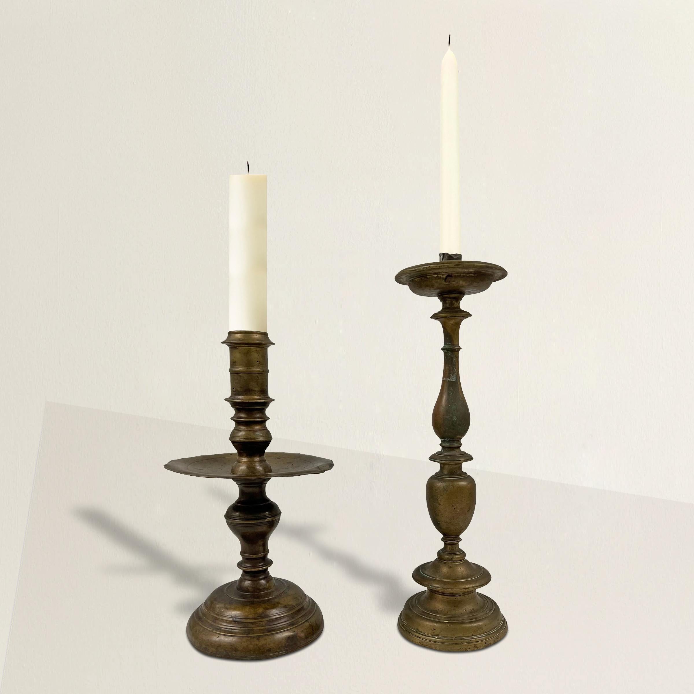 A stunning pair of 17th century Italian Baroque bonze candlesticks with beautifully turned stems. One is a traditional candlestick that holds a taper, and the other is a pricket that holds a larger pillar candle.