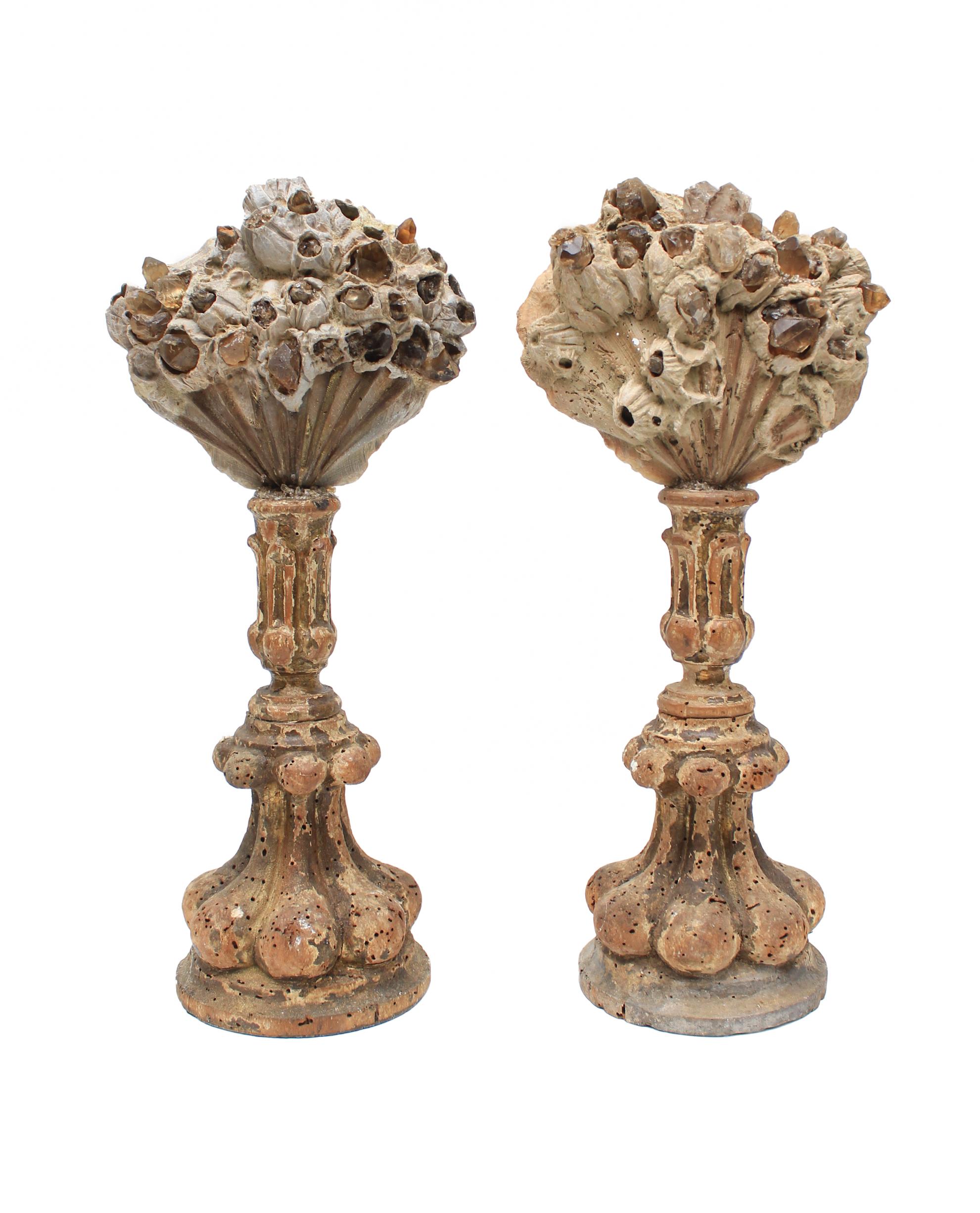 Pair of 17th century Italian candlesticks with Chesapecten shells and adorned with smoky quartz and Herkimer diamonds.

The pair of candlesticks originally came from a church in Tuscany. They are distressed due to period and age. Herkimer diamonds