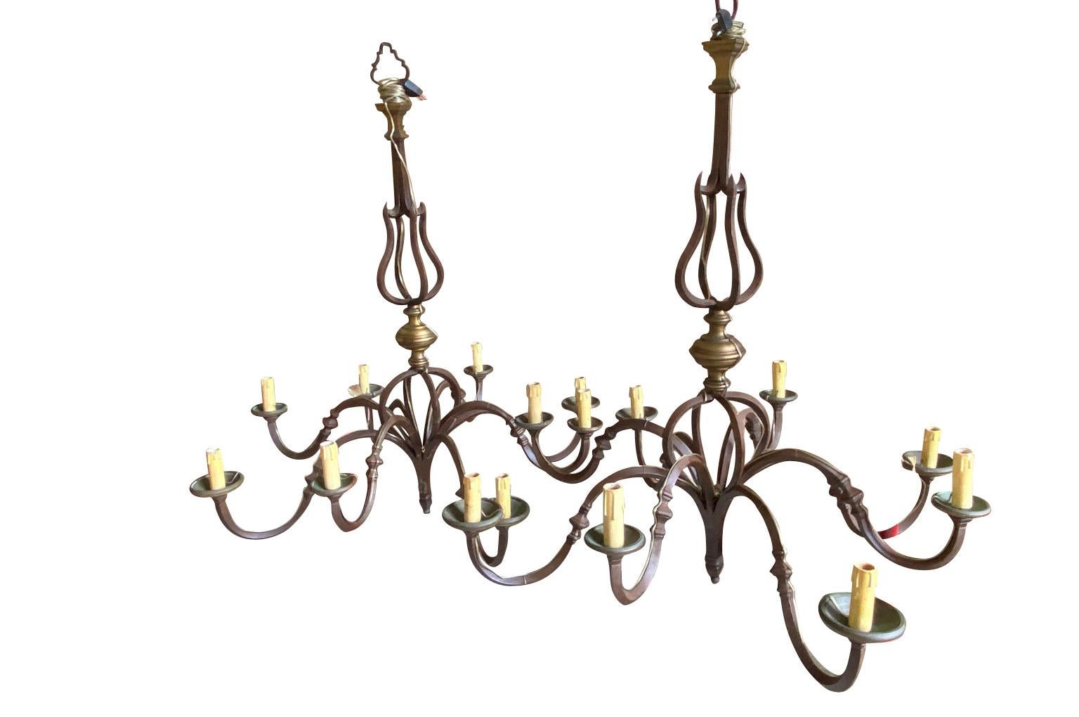 A stunning pair of 17th century Chandeliers from Lombardy region of Italy.  Beautifully crafted from iron and bronze with 8 lights each.  Elegant and understated with excellent patina.