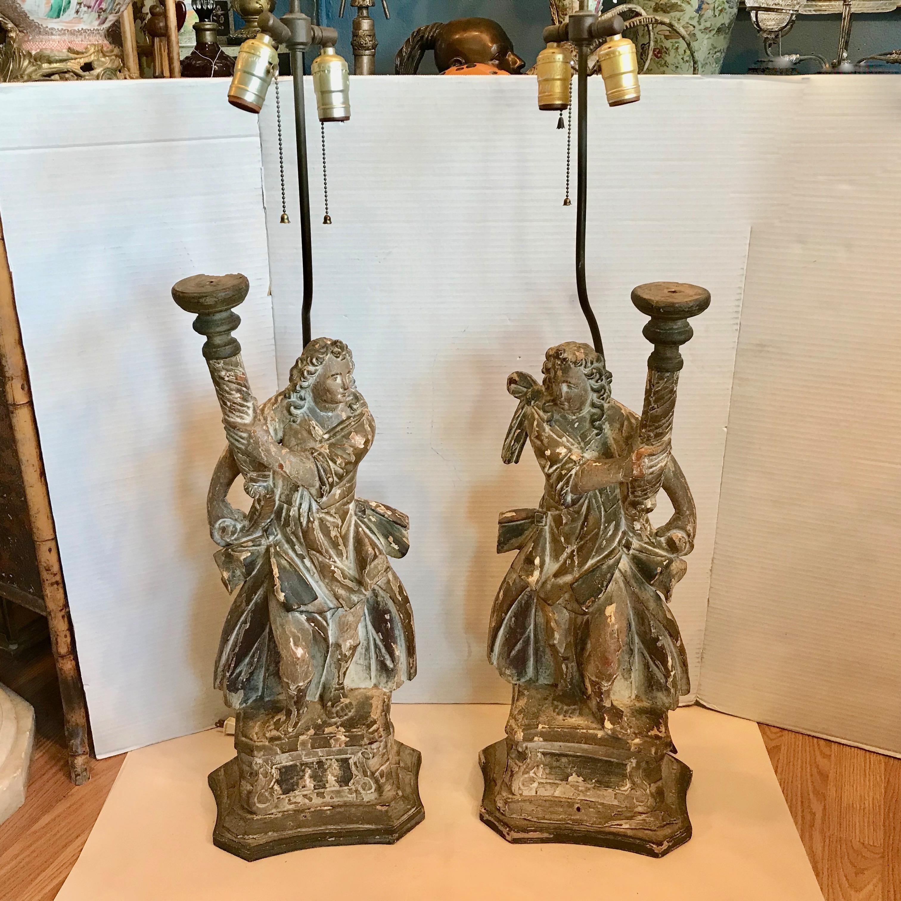 Outstanding and rare depictions. Beautifully carved opposing figures - probably angels, designed with flowing robes. The figures are 
dramatic in form and scale. The natural wood has remnants of old
gesso as they were probably originally gilded or