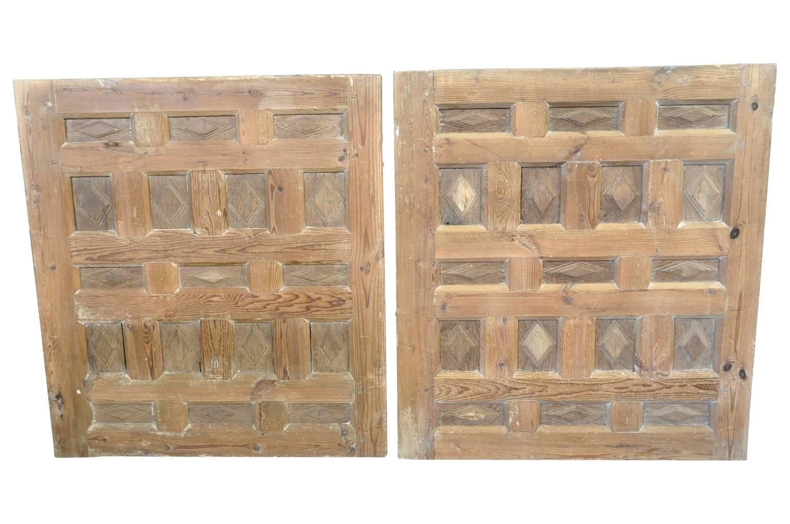 A beautiful pair of Spanish boiserie panels in carved meleze wood - a very hard pine. These panels were wall inserts and seen from both sides. Wonderful architectural accents and perfect as headboards to twin beds.