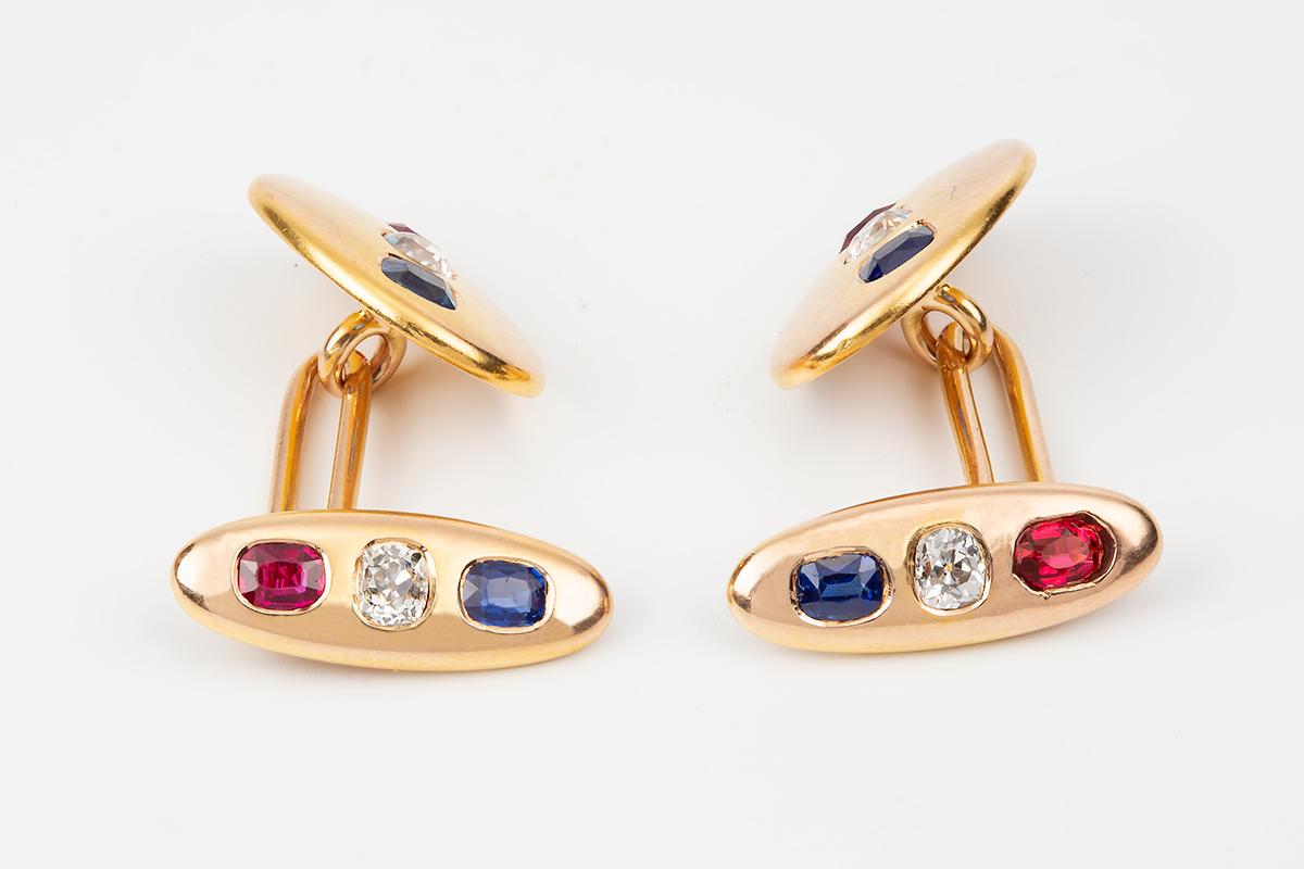 A finely made antique pair of double sided cufflinks in a heavy quality 18 carat yellow gold. Oval in shape and set with an old brilliant cut diamond, a Ceylon sapphire and a Burma ruby, all stones of fine colour. One side is a smaller oval but both