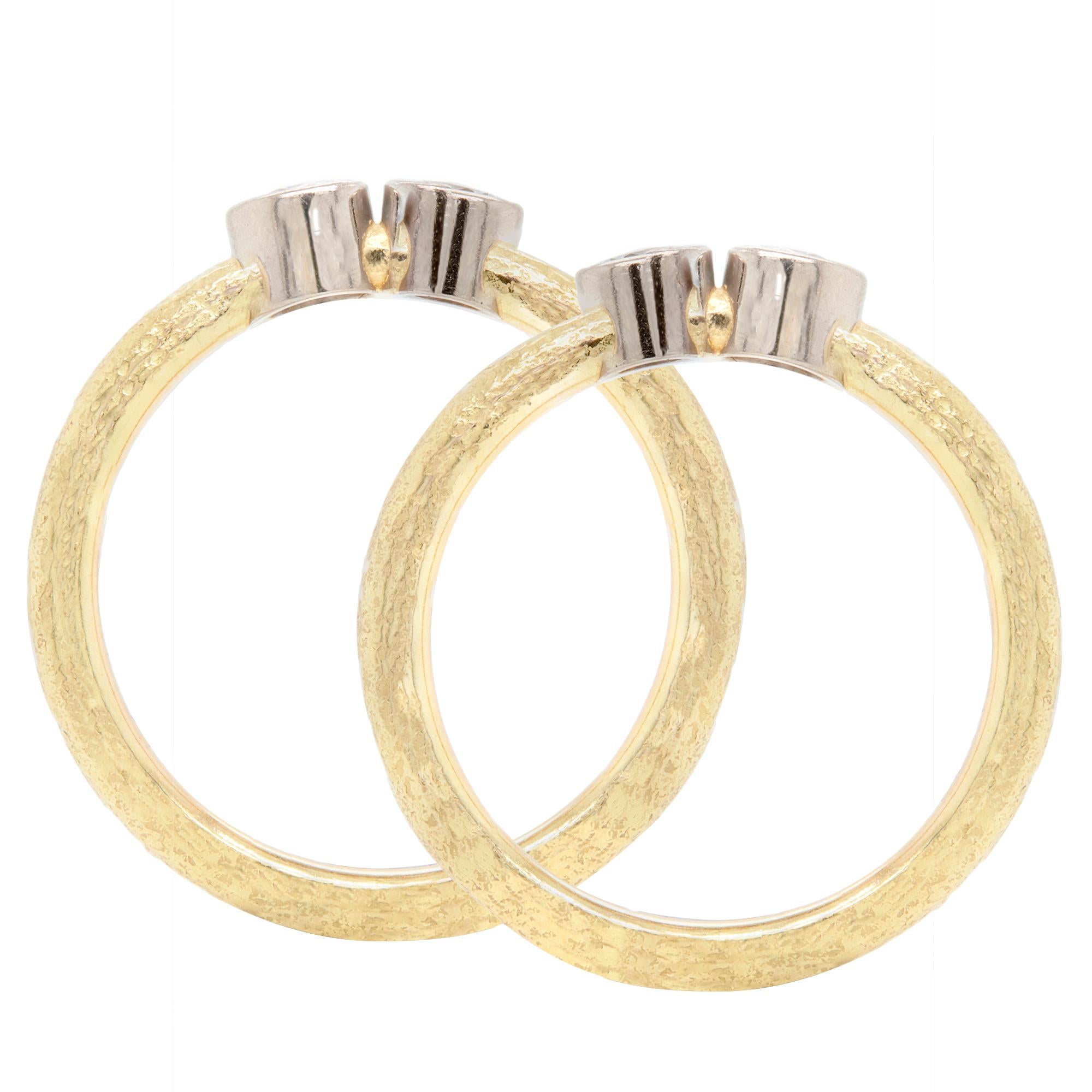 We're in love with this pair of simple but elegant diamond and 18 carat gold stacking rings.

Two beautifully bright round brilliant cut diamonds have been expertly rub-over set into individual white gold collets in each ring, sitting proud of the