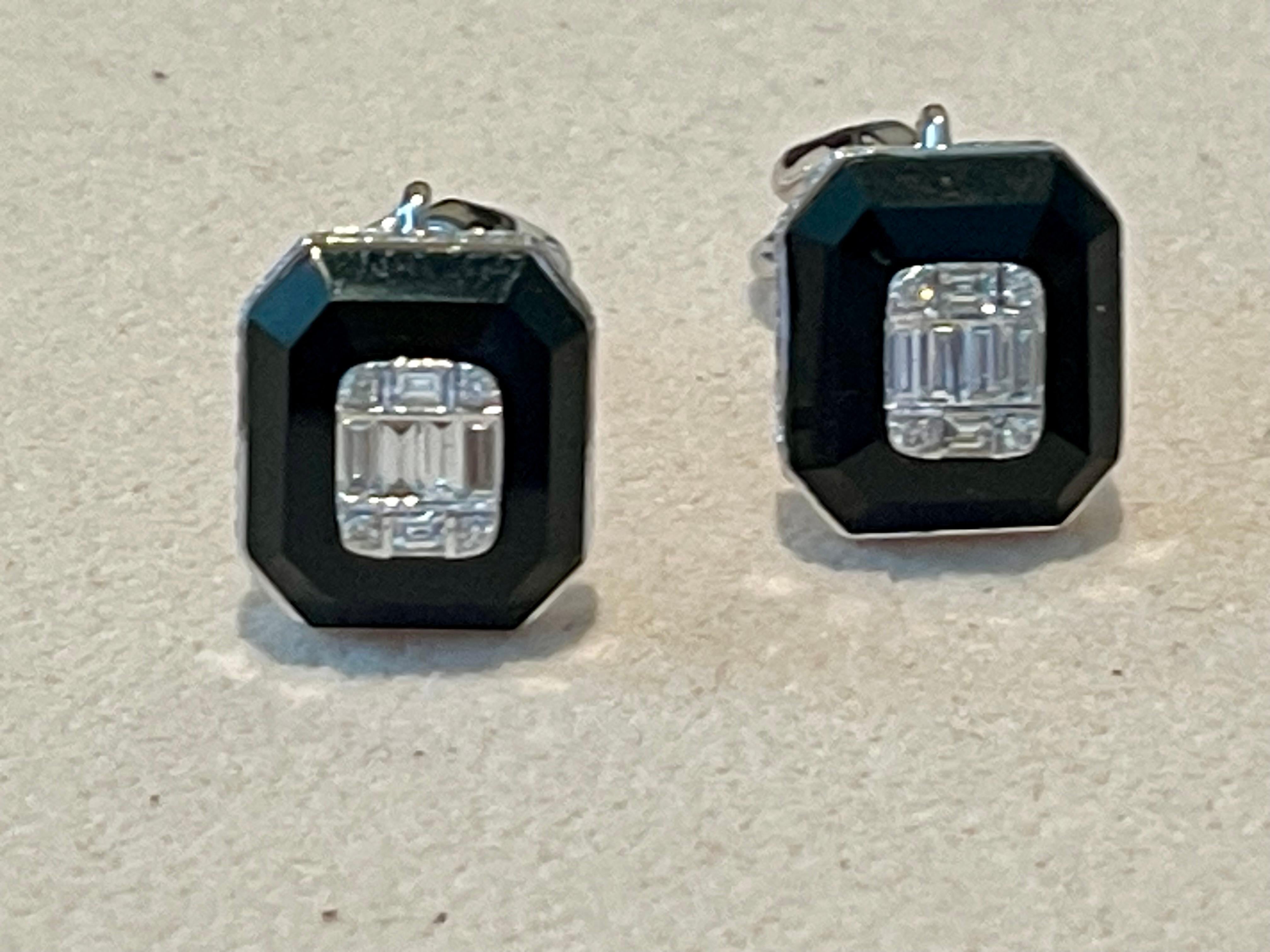 A pair of very elegant and timeless 18 K white Gold earrstud with Onyx and Diamonds. Set with 12 baguette cut Diamonds weighing 0.46 ct, 86 brilliant cut Diamonds weighing 0.55 ct, all H color, vs clarity. 
Comfortable wear with Omega fix post!