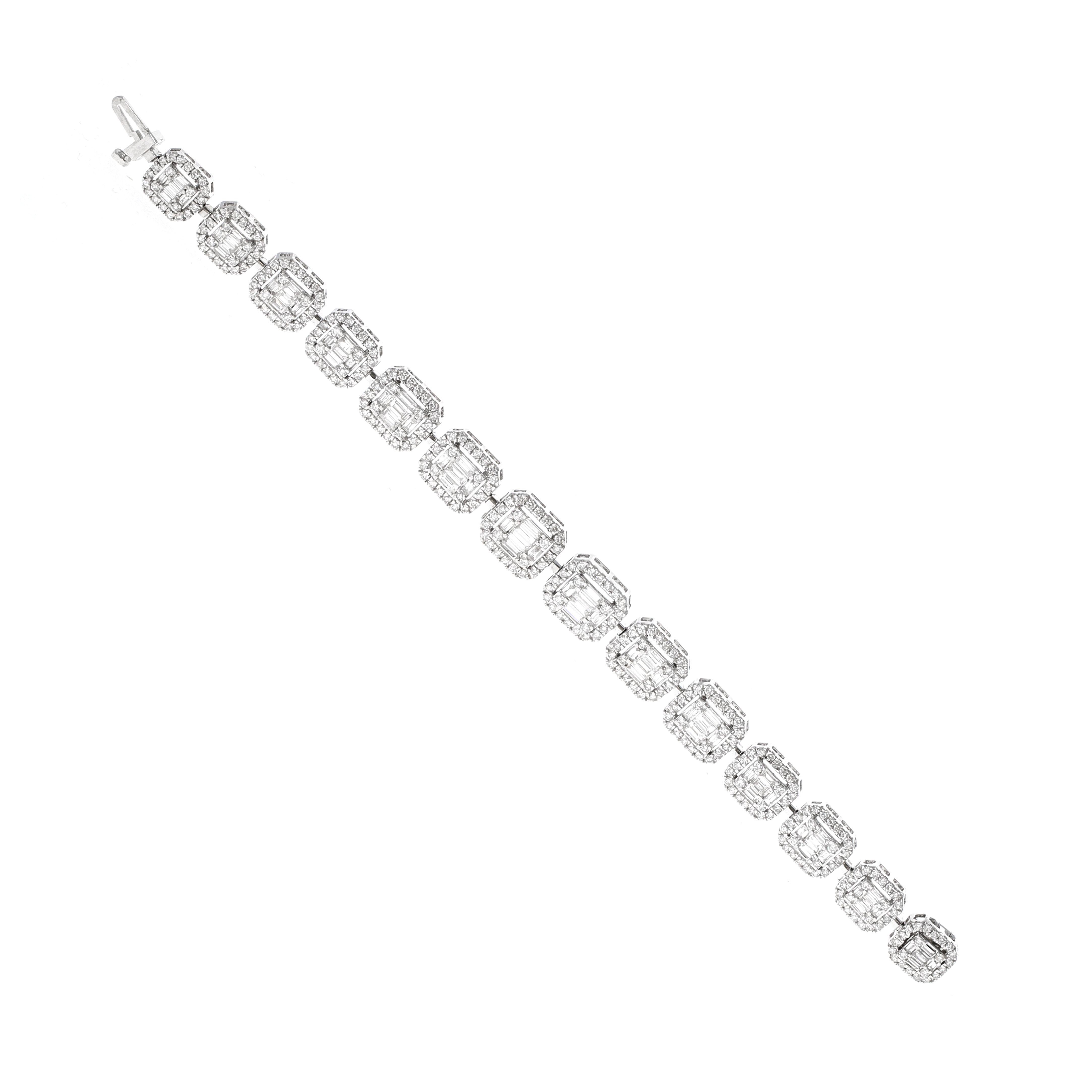 Matching pair of 18 karat white gold diamond illusion bracelets. The diamonds are made to look like one large stone, however, they are made with baguette and round shape diamonds. An illusion setting enhances the appearance, and the perceived size
