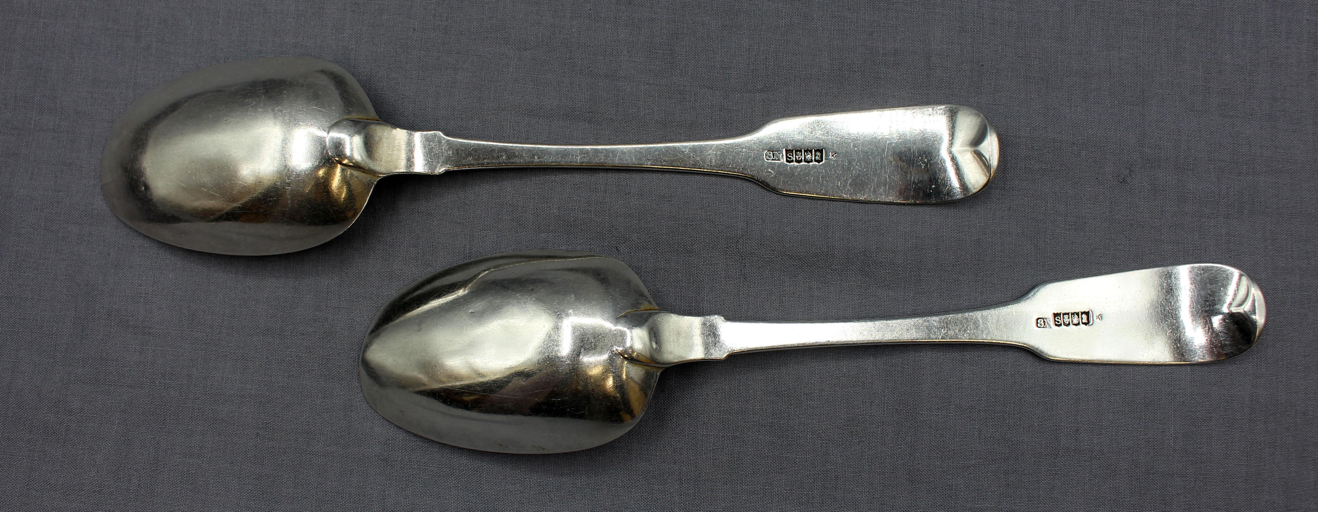 1818 pair of Irish sterling silver table or serving spoons by Samuel Neville. Fiddleback pattern. Dublin. Crested with a goat's head erased. Worn bowl tips. 4.10 troy oz.
8.75