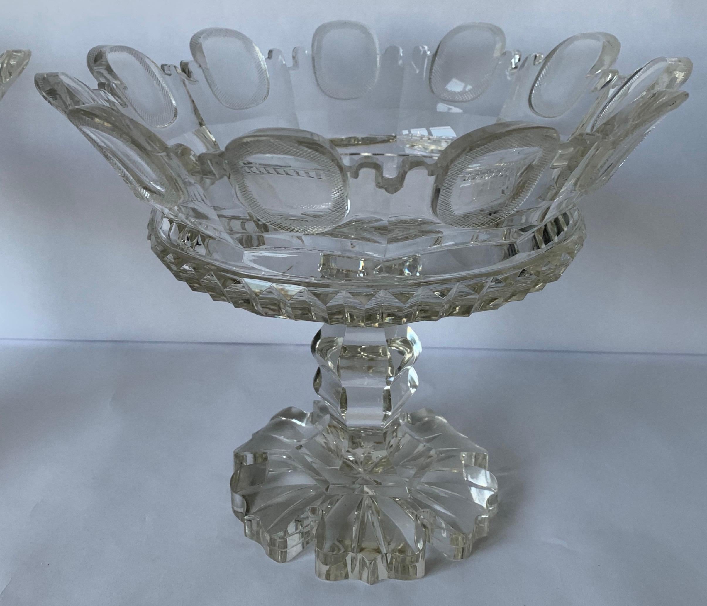 Pair of Anglo-Irish cut crystal mantel (fireplace) vases circa 1820. Cremelated Diamond and sawtooth cut tops with strawberry diamond panels and Gothic arches. Multiple stepped plinths. Strawberry diamond cutting on the bottom. No makers mark or
